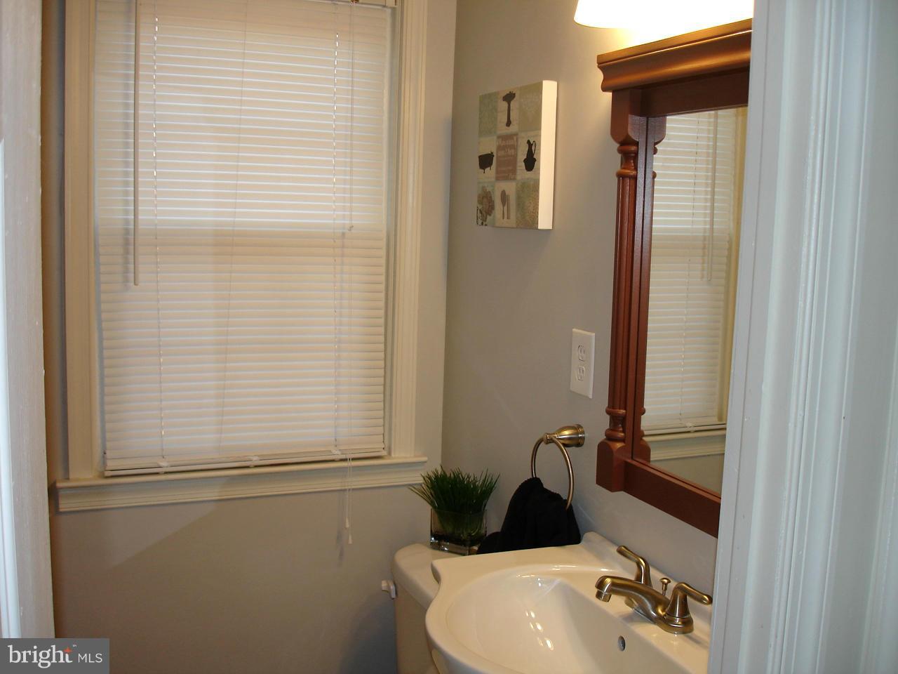 3412 Dunran Road Dundalk, MD 21222 - Photo 11 of 25 a bathroom with a sink and mirror