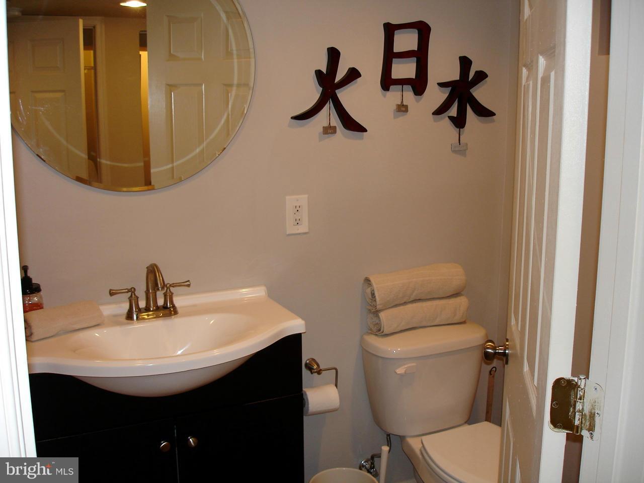 3412 Dunran Road Dundalk, MD 21222 - Photo 17 of 25 a bathroom with a toilet a sink and a mirror