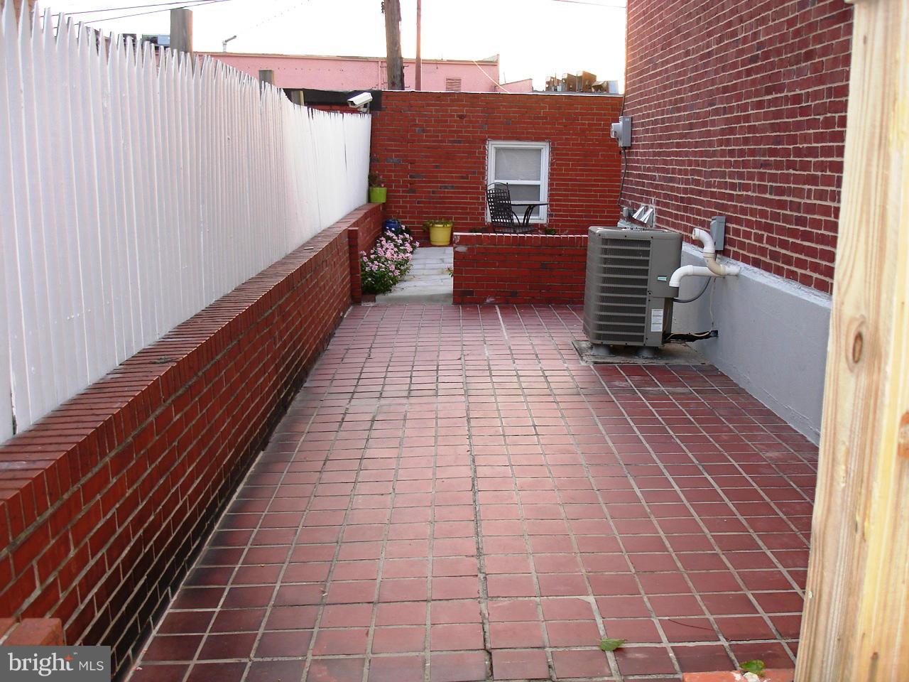 3412 Dunran Road Dundalk, MD 21222 - Photo 20 of 25 a view of a patio with wooden floor and brick walls