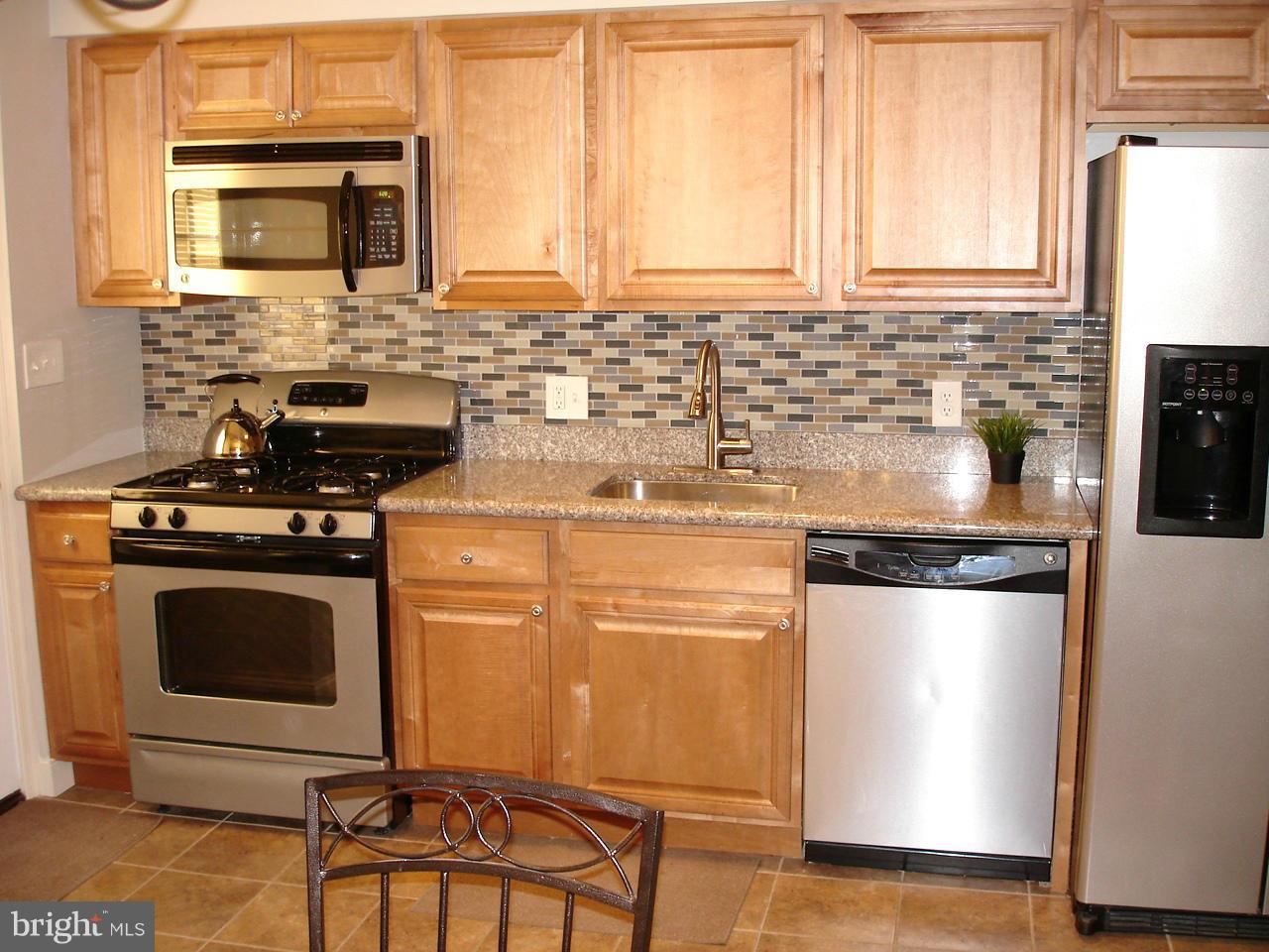 3412 Dunran Road Dundalk, MD 21222 - Photo 5 of 25 a kitchen with stainless steel appliances granite countertop a stove a sink and a microwave