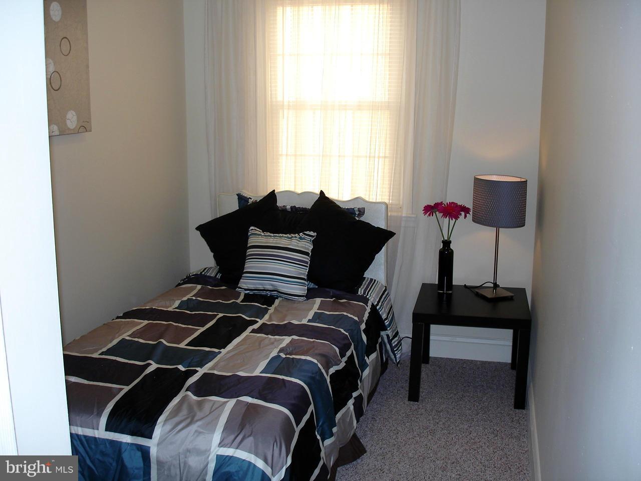 3412 Dunran Road Dundalk, MD 21222 - Photo 9 of 25 a bedroom with a bed and a window