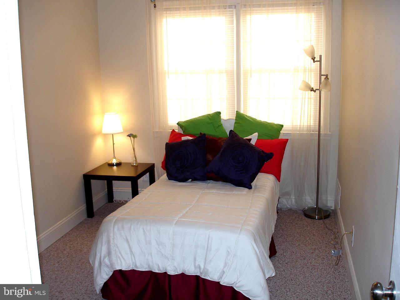 3412 Dunran Road Dundalk, MD 21222 - Photo 10 of 25 a bedroom with a bed table and a window