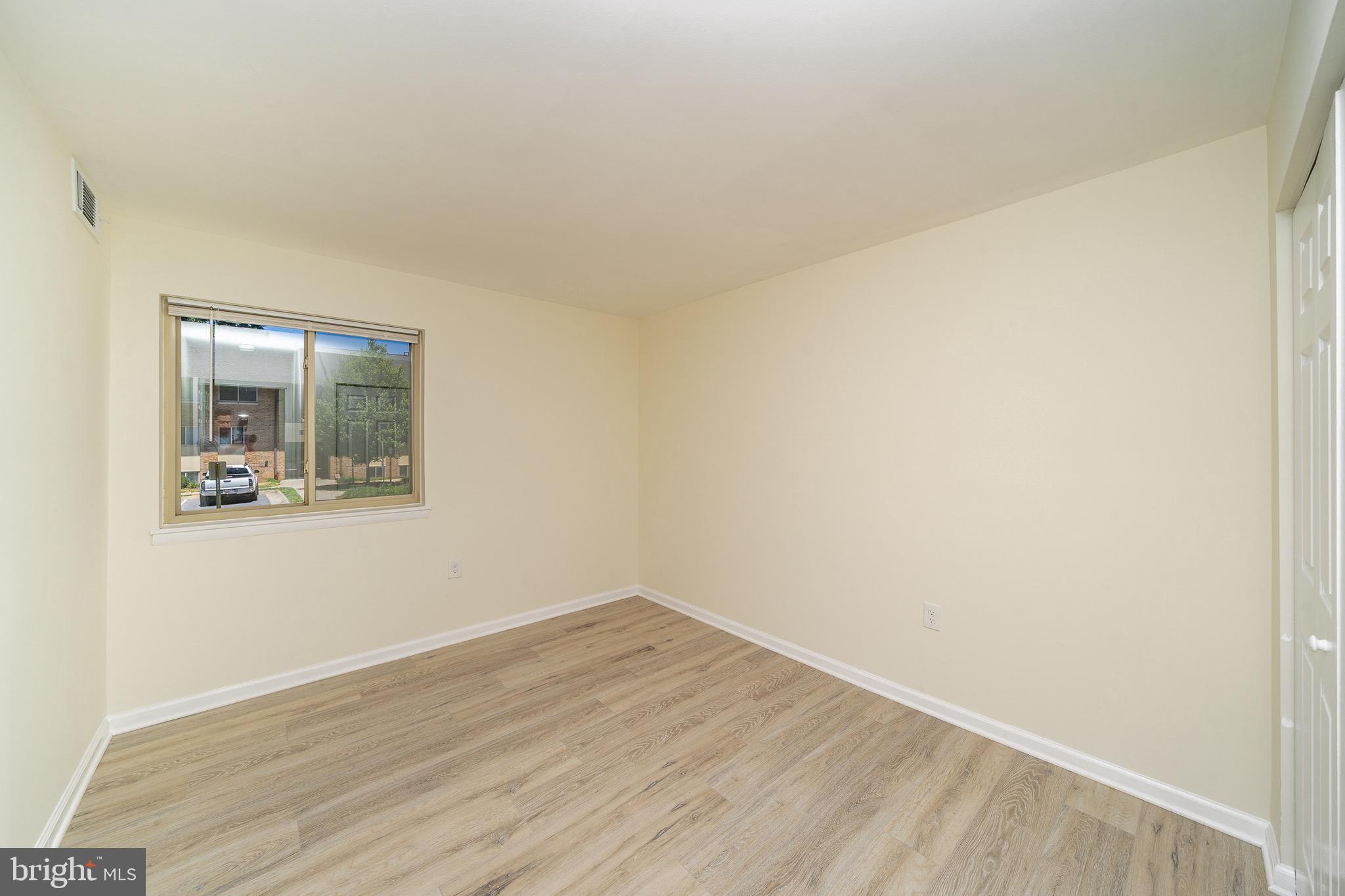 9910 Walker House Road, Unit 99104 Gaithersburg, MD 20886 - Photo 27 of 32 wooden floor in an empty room