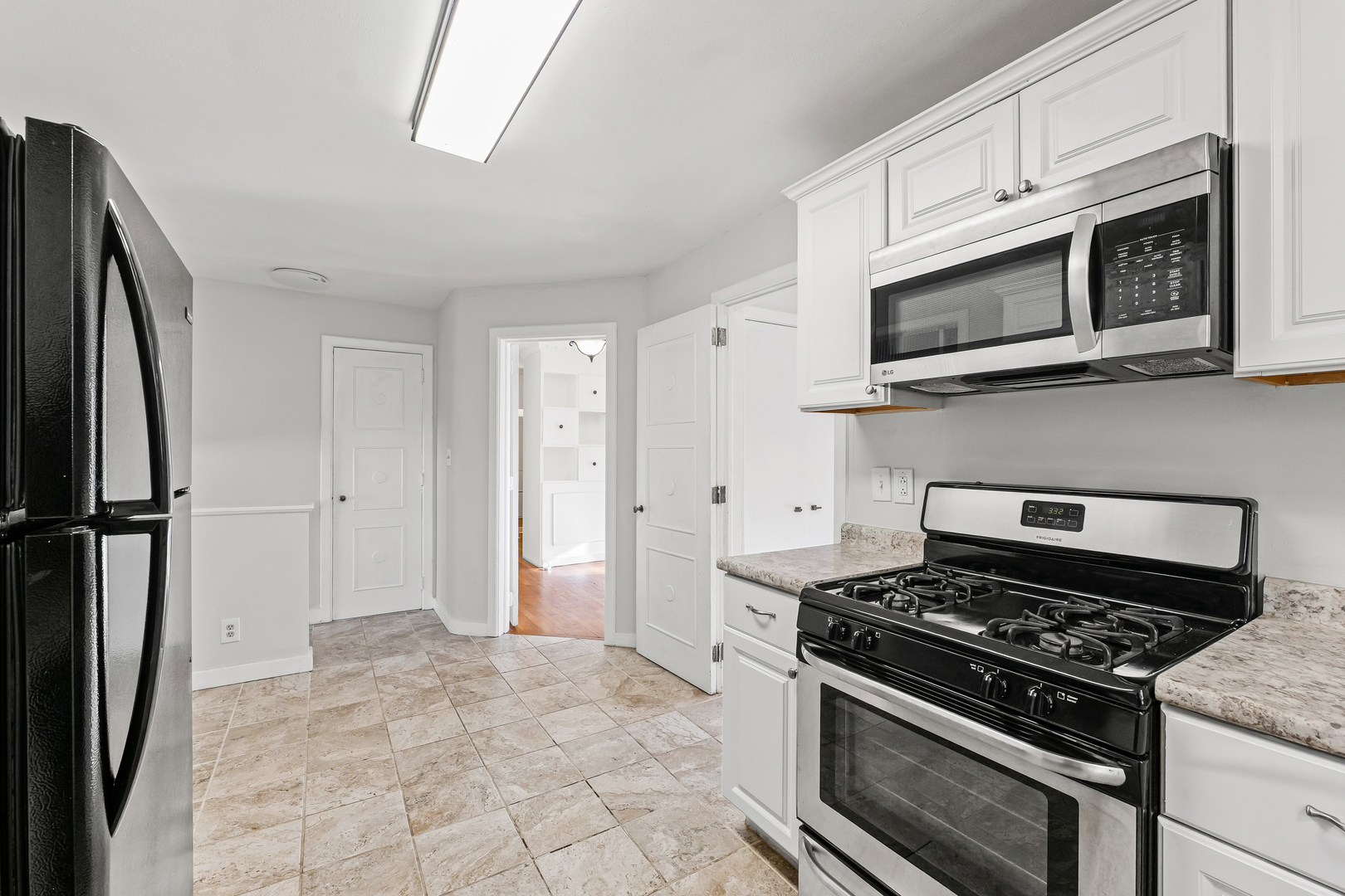 302 Flora Drive Champaign, IL 61821 - Photo 11 of 34 a kitchen with stainless steel appliances a stove a microwave and a refrigerator