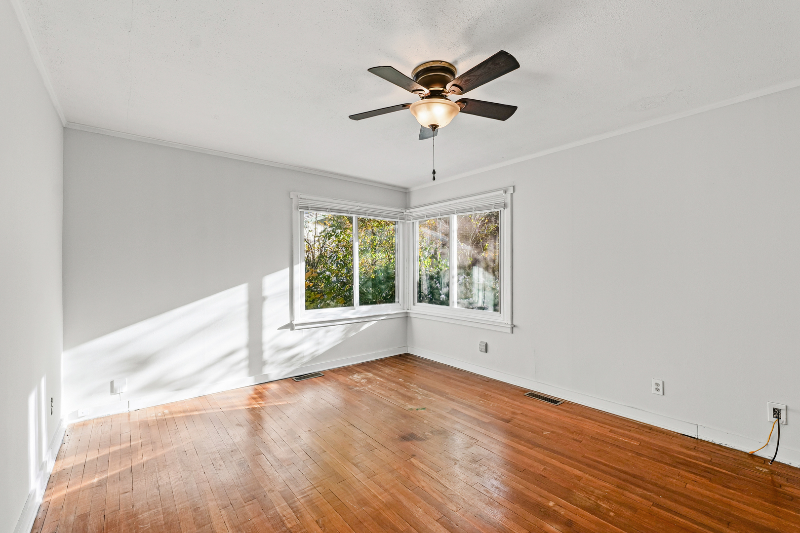 302 Flora Drive Champaign, IL 61821 - Photo 21 of 34 wooden floor in an empty room with a window