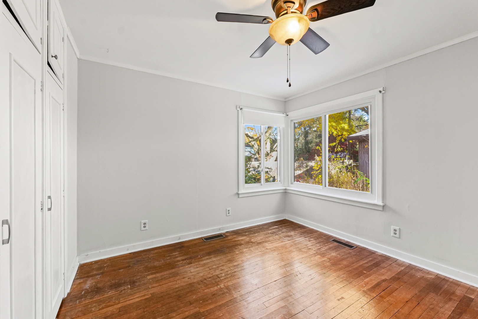 302 Flora Drive Champaign, IL 61821 - Photo 23 of 34 an empty room with windows and chandelier fan