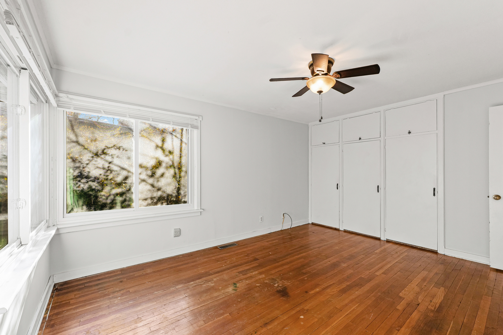 302 Flora Drive Champaign, IL 61821 - Photo 26 of 34 a view of empty room with wooden floor and fan