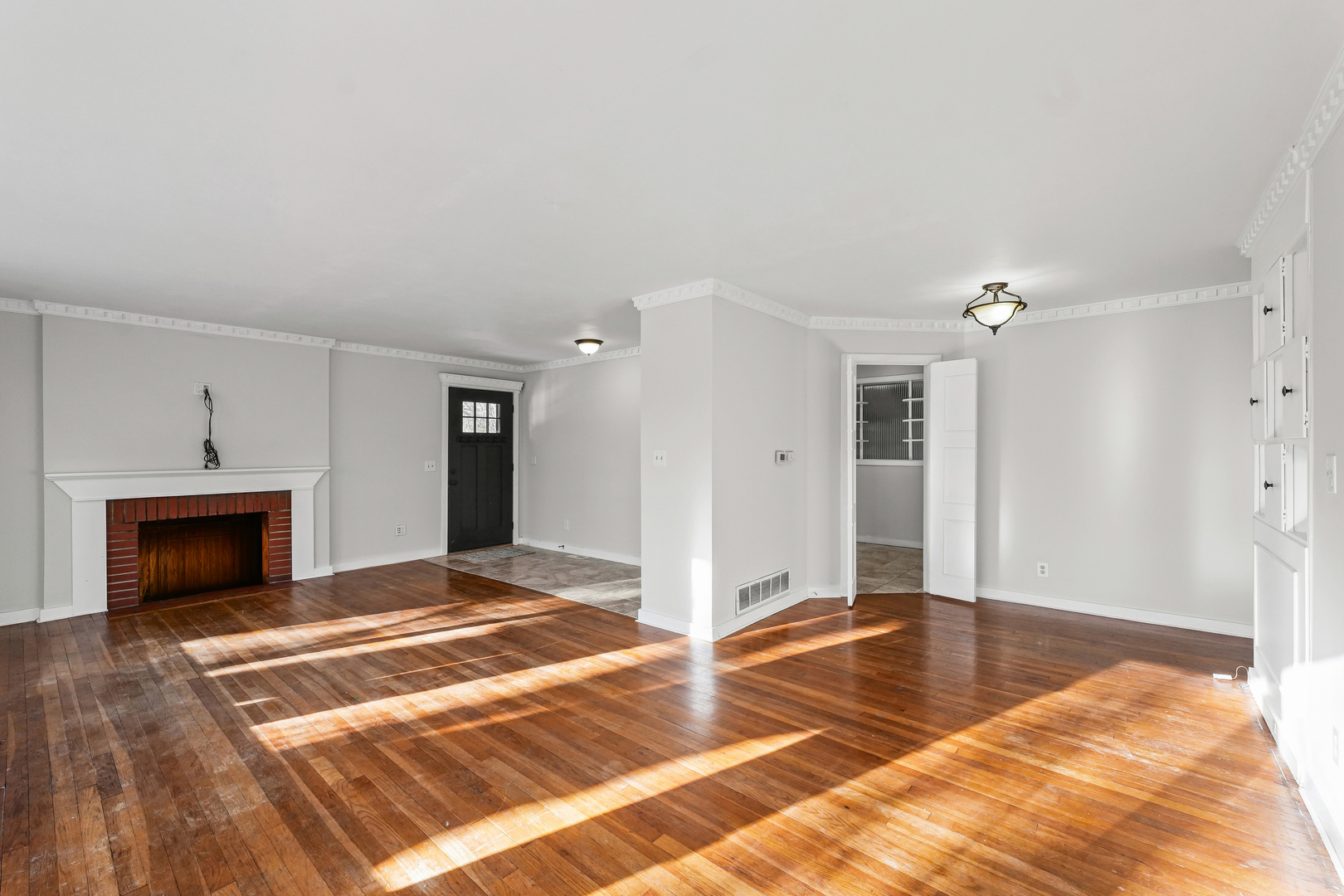 302 Flora Drive Champaign, IL 61821 - Photo 5 of 34 a view of a livingroom with wooden floor and a fireplace