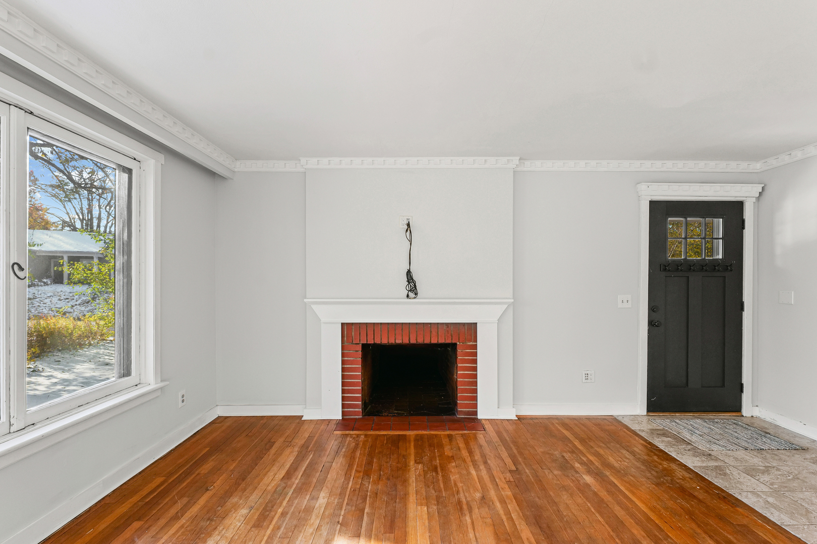 302 Flora Drive Champaign, IL 61821 - Photo 6 of 34 a view of an empty room with a fireplace and a window