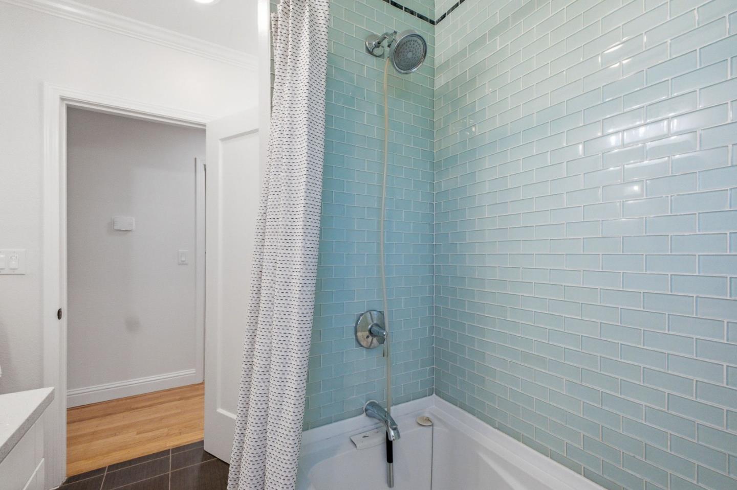 9858 Golf Links Road Oakland, CA 94605 - Photo 25 of 39 a bathroom with a shower and a toilet