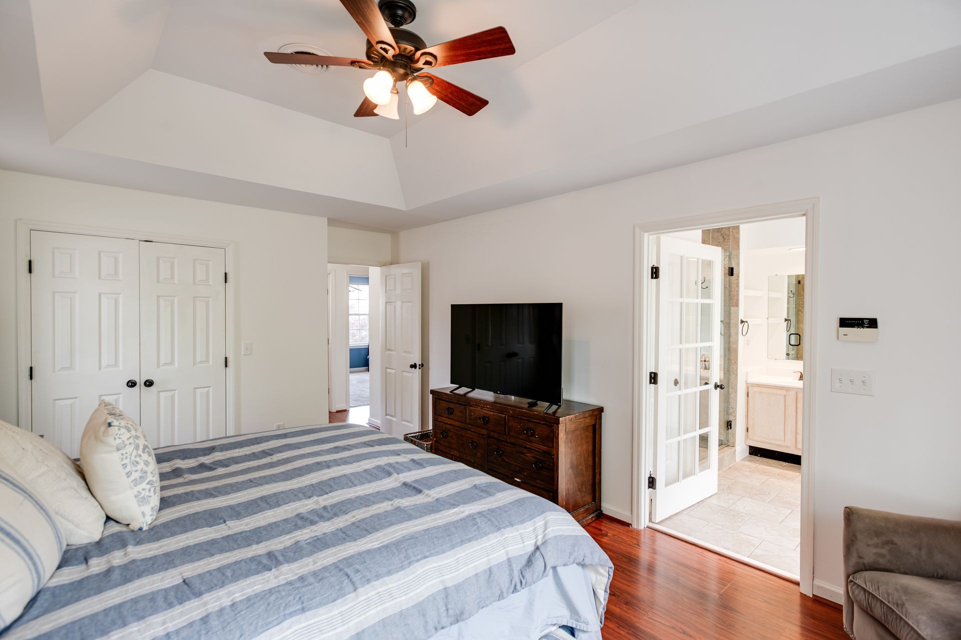 1065 Meandering Way Franklin, TN 37067 - Photo 17 of 33 a bedroom with a bed and a flat screen tv