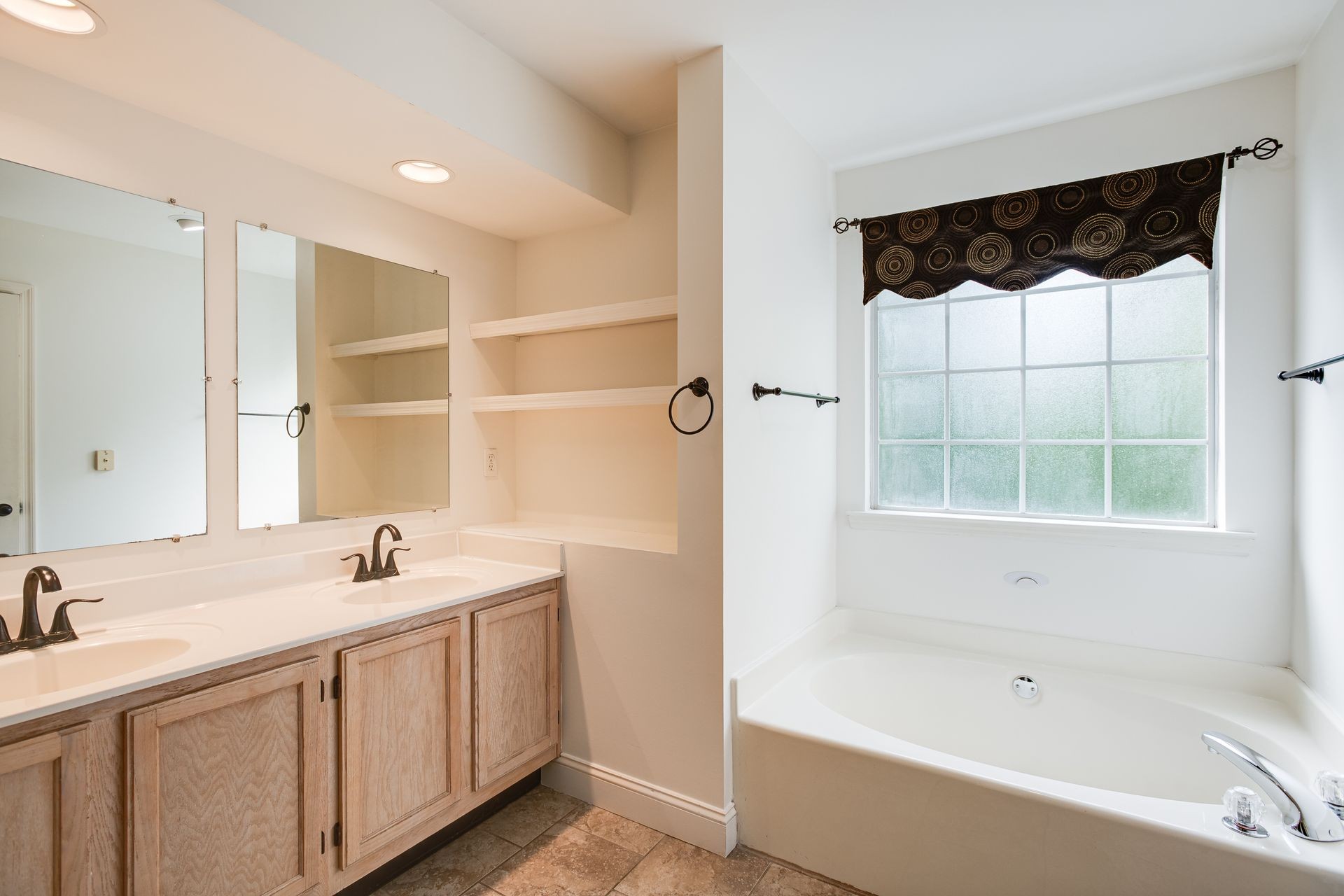 1065 Meandering Way Franklin, TN 37067 - Photo 18 of 33 a bathroom with a bathtub a sink and a shower