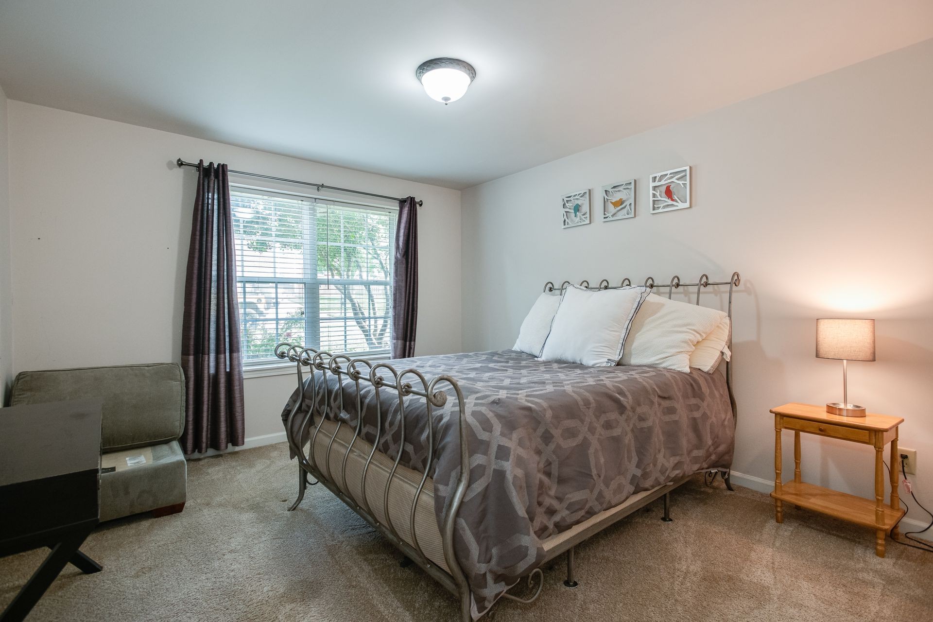 1065 Meandering Way Franklin, TN 37067 - Photo 21 of 33 a bed sitting in a bedroom next to a window