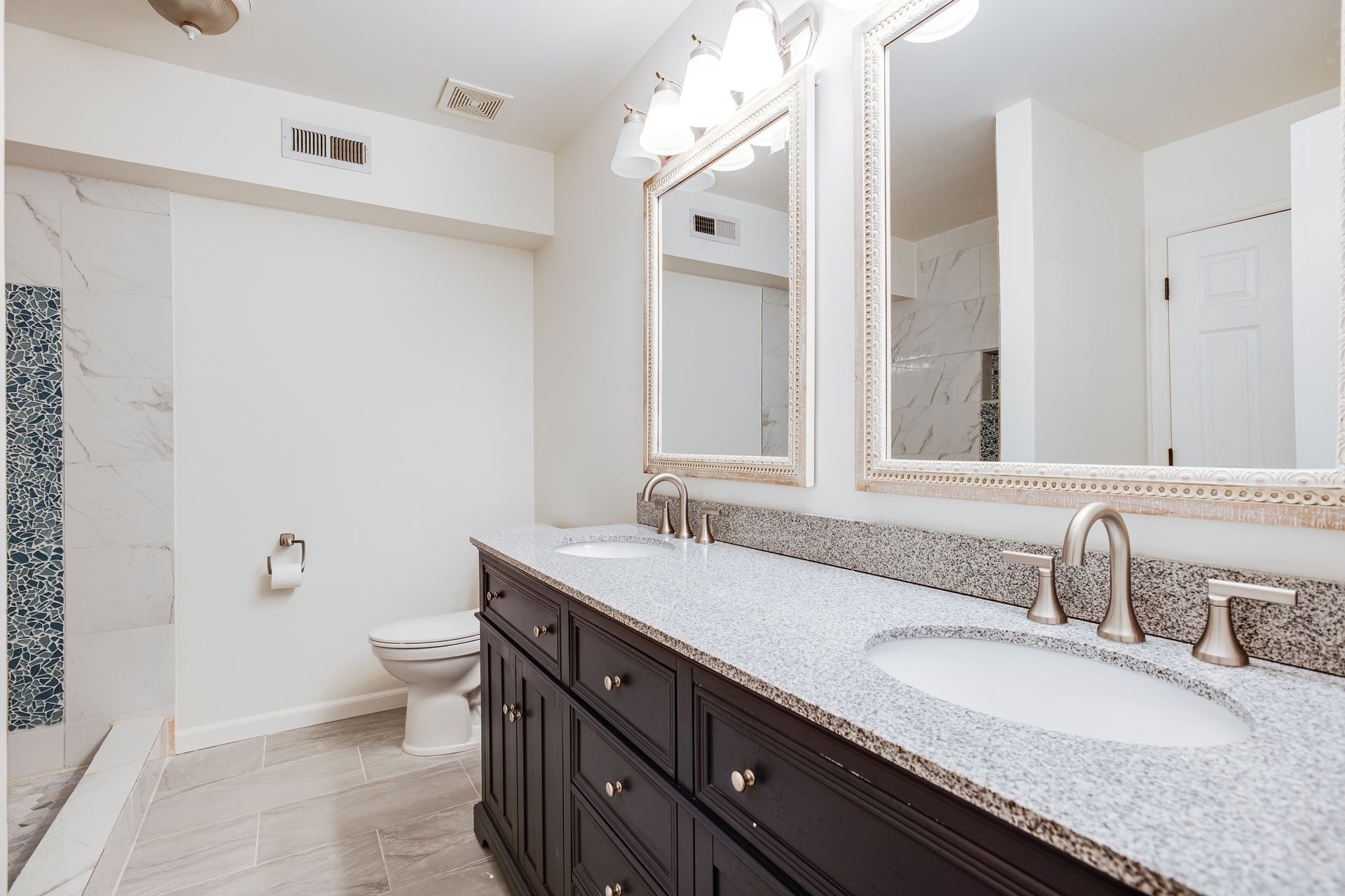 1065 Meandering Way Franklin, TN 37067 - Photo 24 of 33 a bathroom with a granite countertop sink a toilet and a mirror