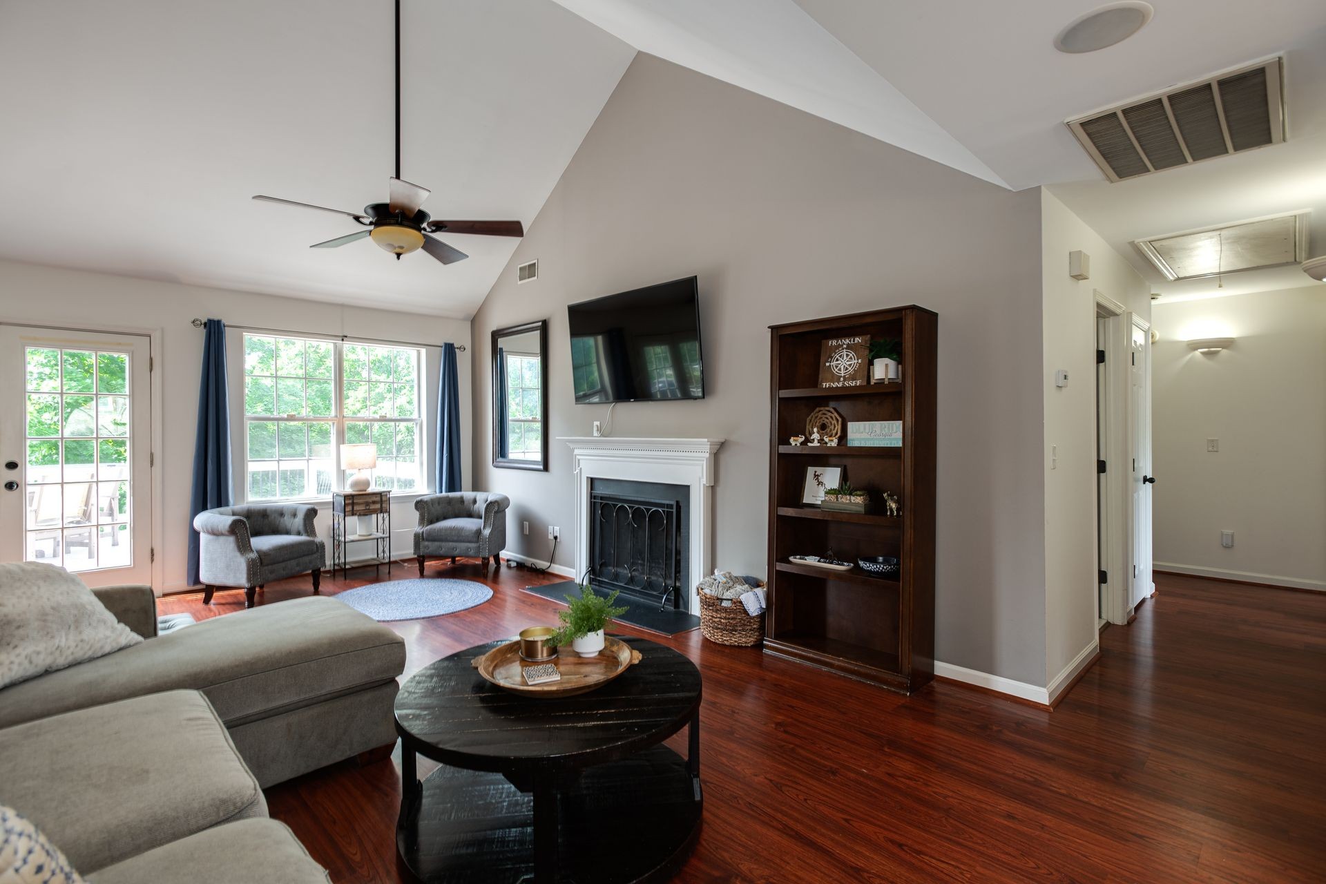 1065 Meandering Way Franklin, TN 37067 - Photo 4 of 33 a living room with furniture a fireplace and a flat screen tv