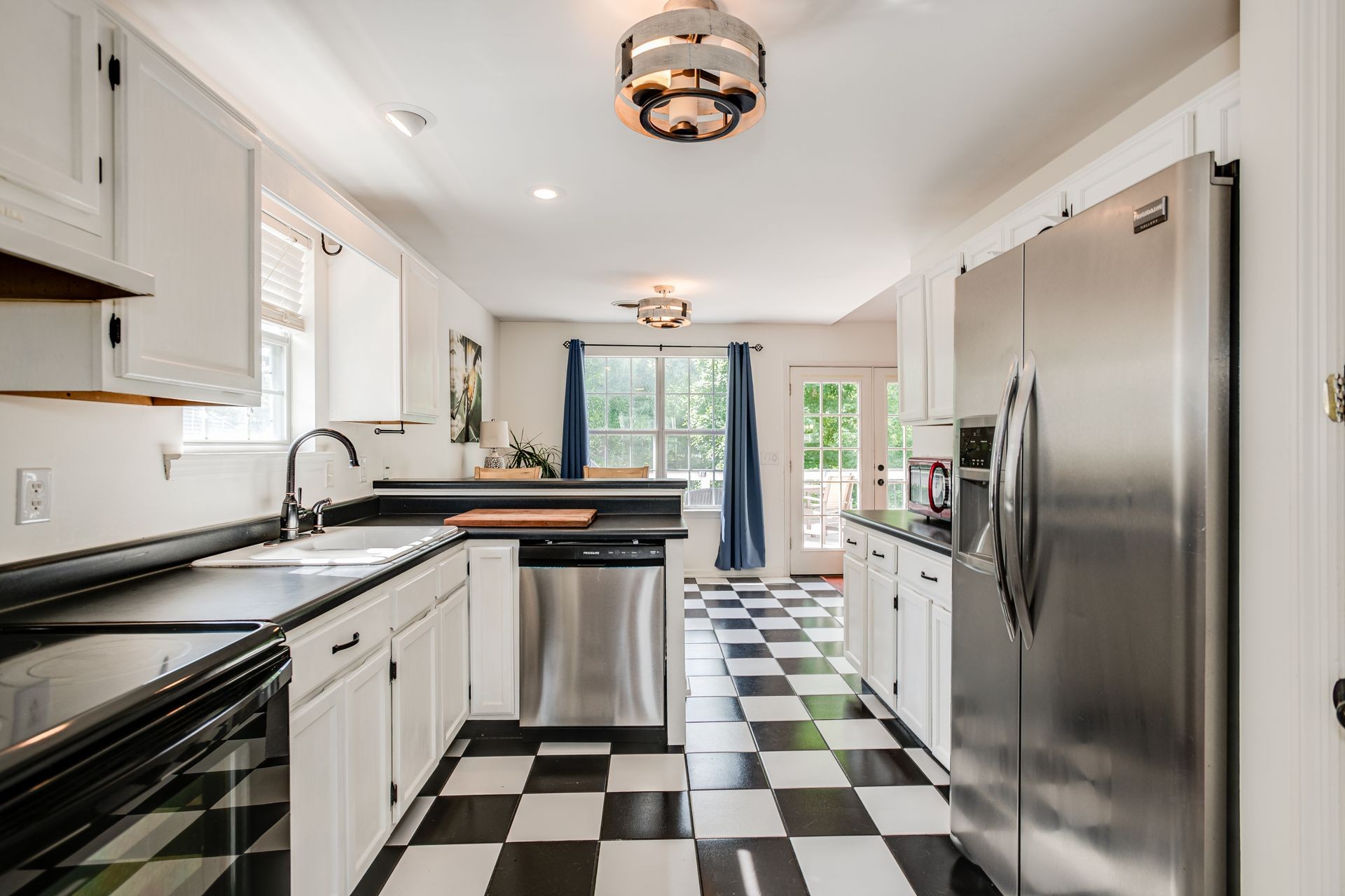 1065 Meandering Way Franklin, TN 37067 - Photo 7 of 33 a kitchen with stainless steel appliances granite countertop a sink stove and refrigerator