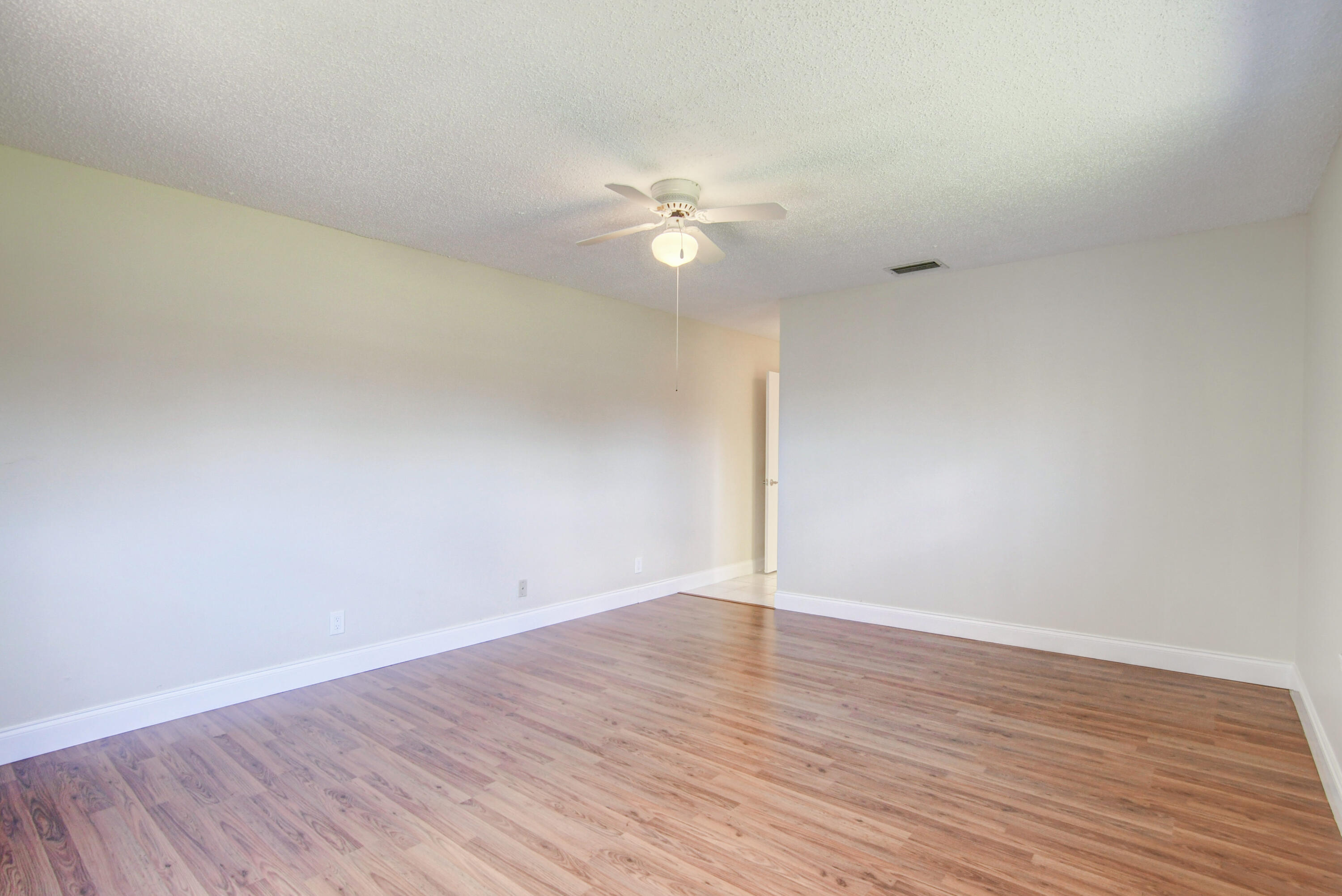 4867 Hawkwood Road, Unit B Boynton Beach, FL 33436 - Photo 19 of 37 wooden floor in an empty room