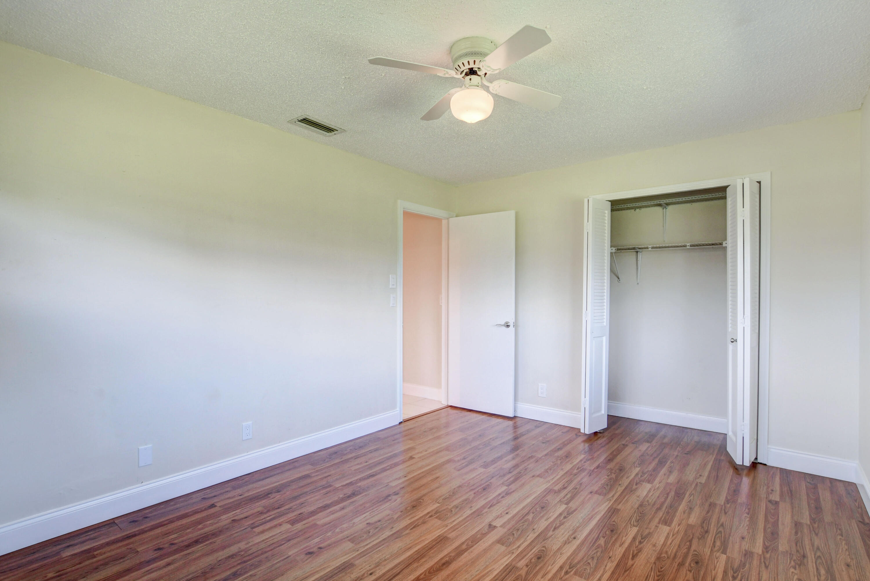 4867 Hawkwood Road, Unit B Boynton Beach, FL 33436 - Photo 26 of 37 a view of an empty room with wooden floor