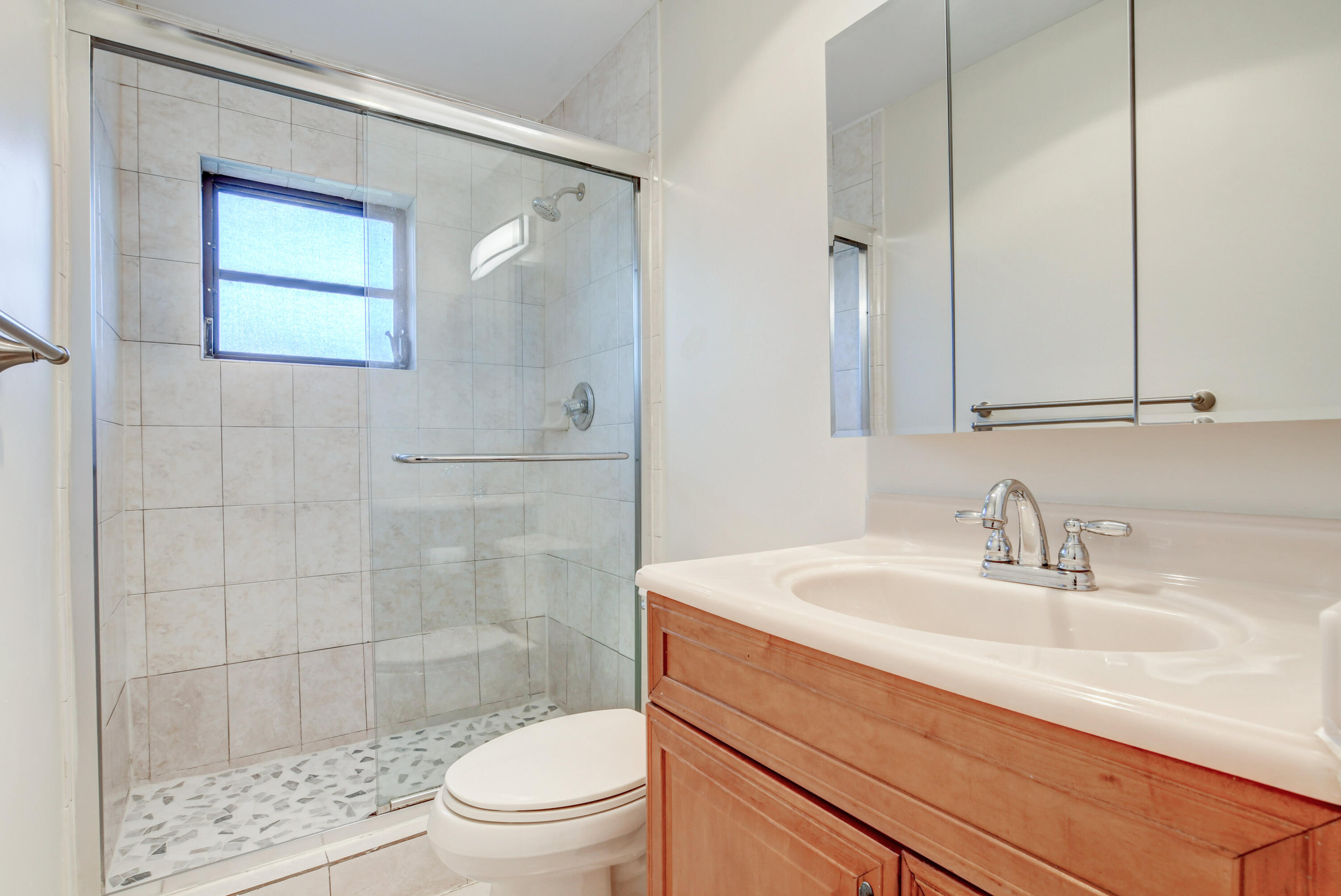 4867 Hawkwood Road, Unit B Boynton Beach, FL 33436 - Photo 28 of 37 a bathroom with a sink a toilet and shower