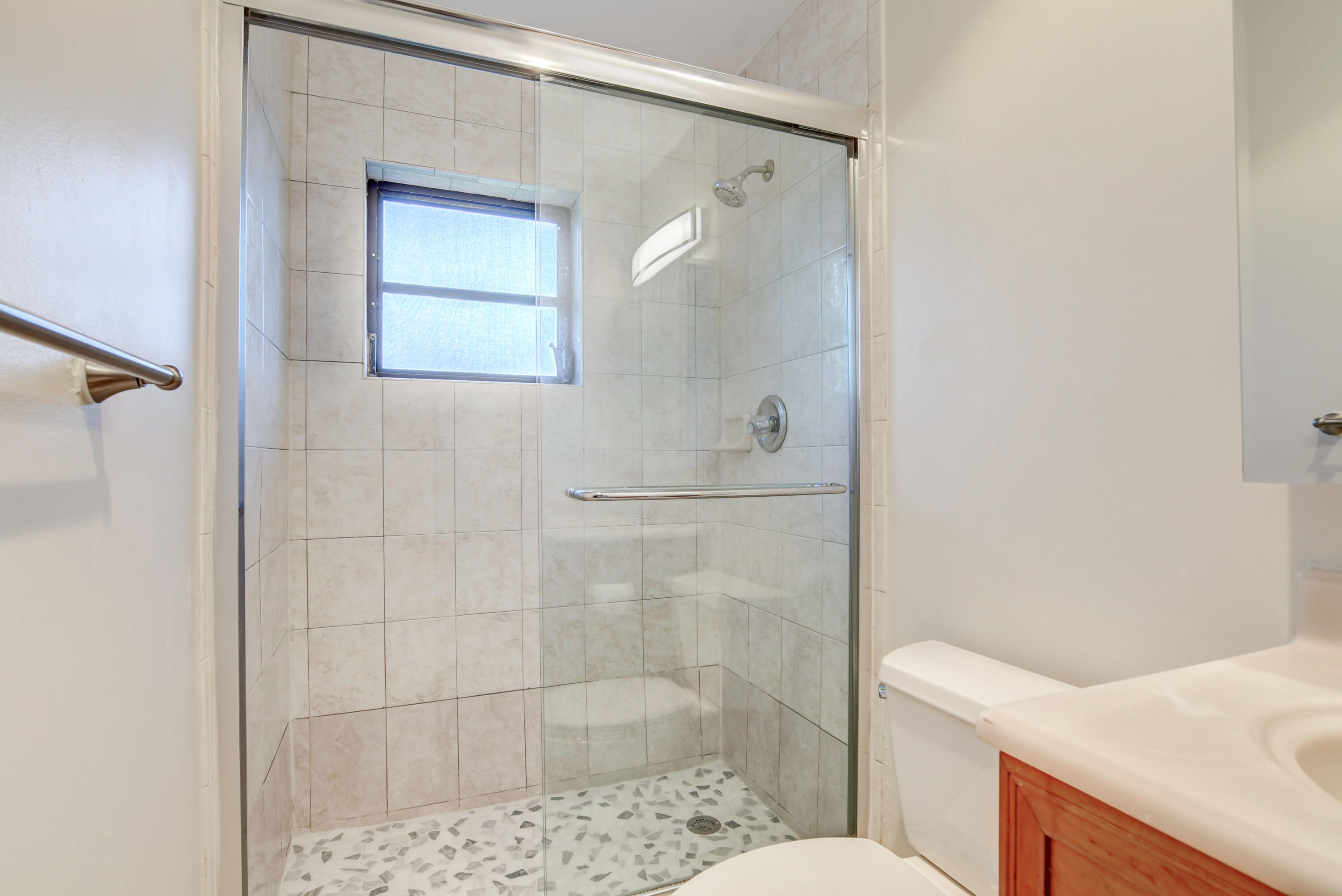 4867 Hawkwood Road, Unit B Boynton Beach, FL 33436 - Photo 29 of 37 a bathroom with a shower and toilet