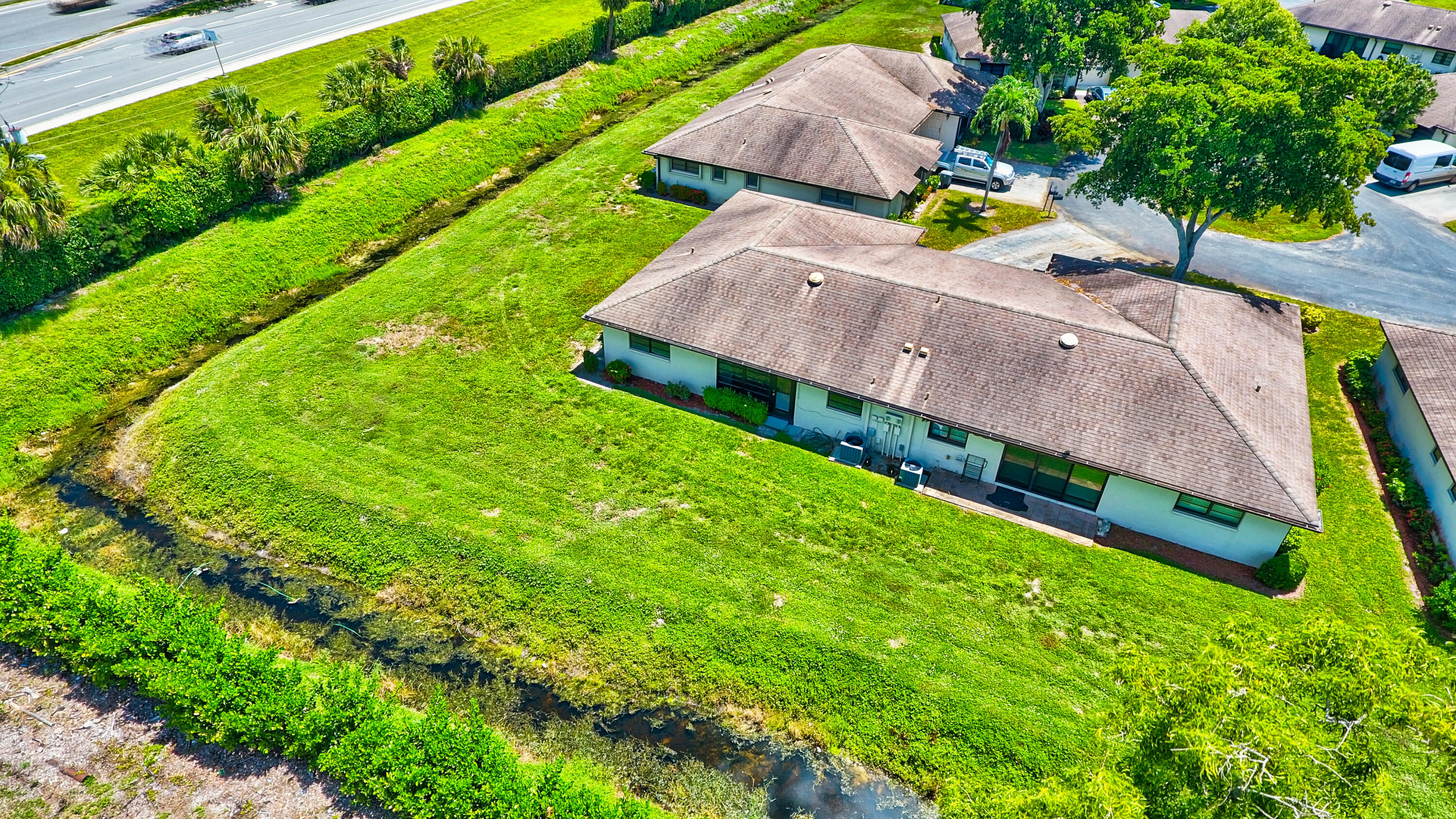 4867 Hawkwood Road, Unit B Boynton Beach, FL 33436 - Photo 31 of 37 an aerial view of a house with a yard basket ball court and parked