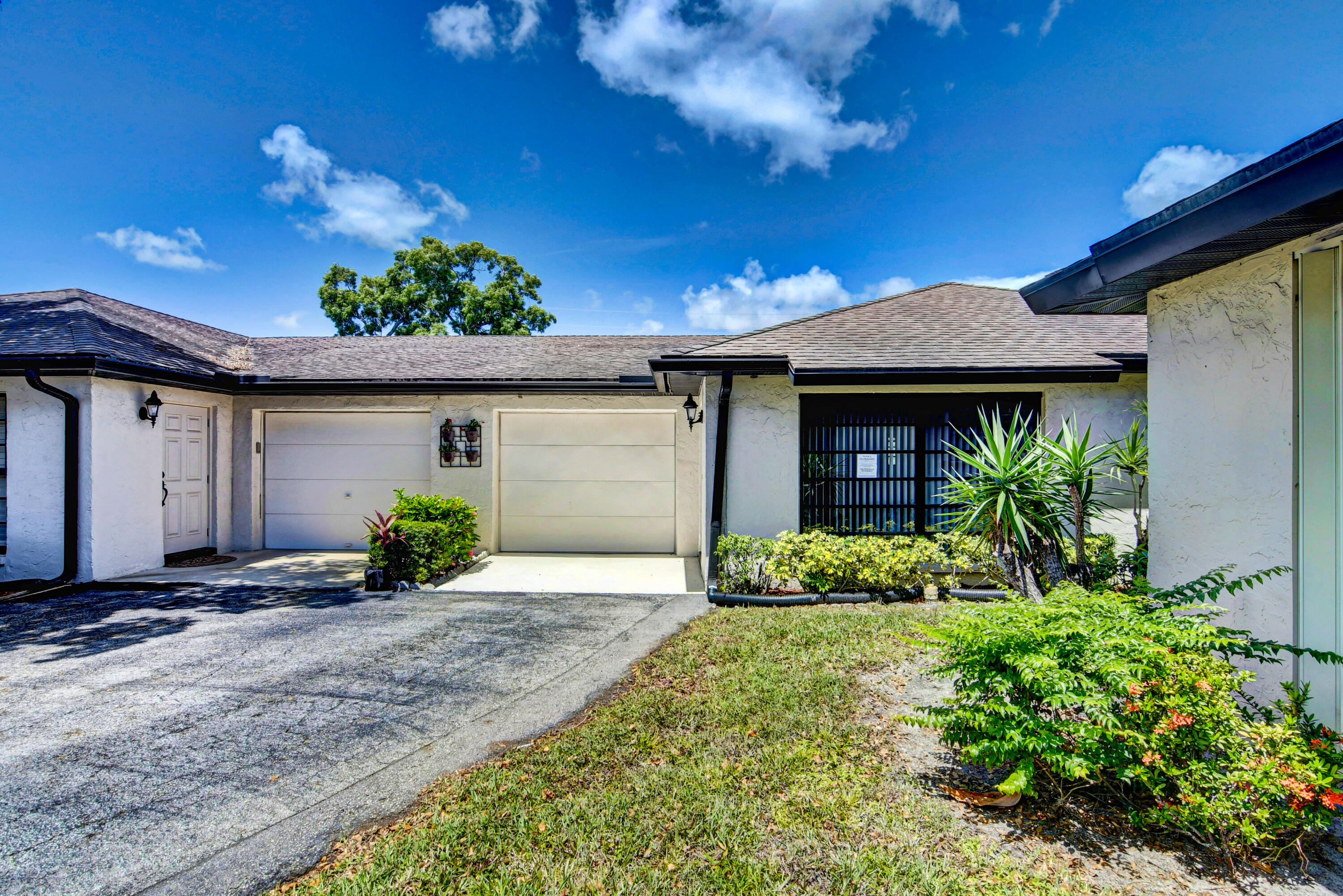 4867 Hawkwood Road, Unit B Boynton Beach, FL 33436 - Photo 33 of 37 a front view of a house with a yard