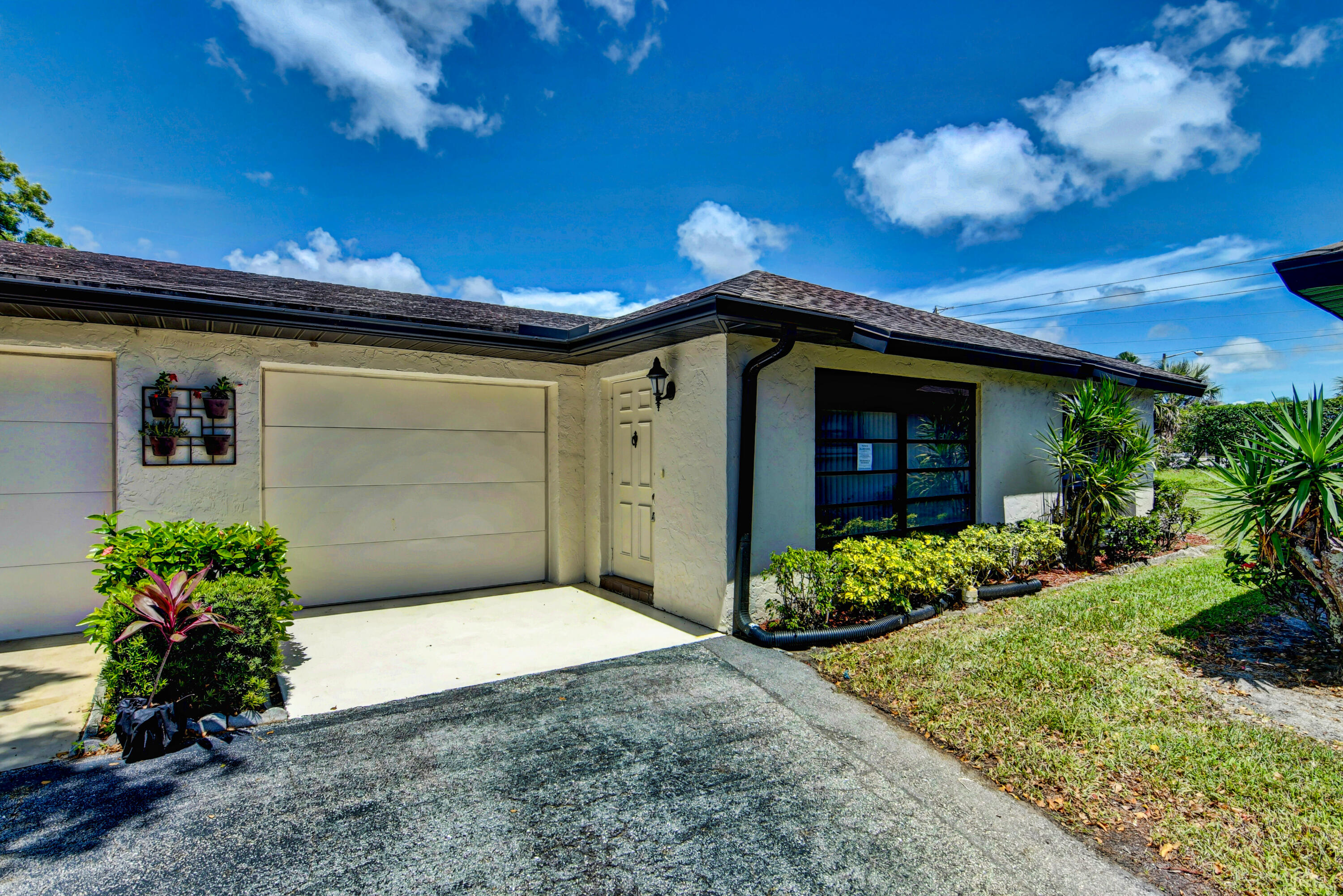 4867 Hawkwood Road, Unit B Boynton Beach, FL 33436 - Photo 34 of 37 a front view of a house with a yard