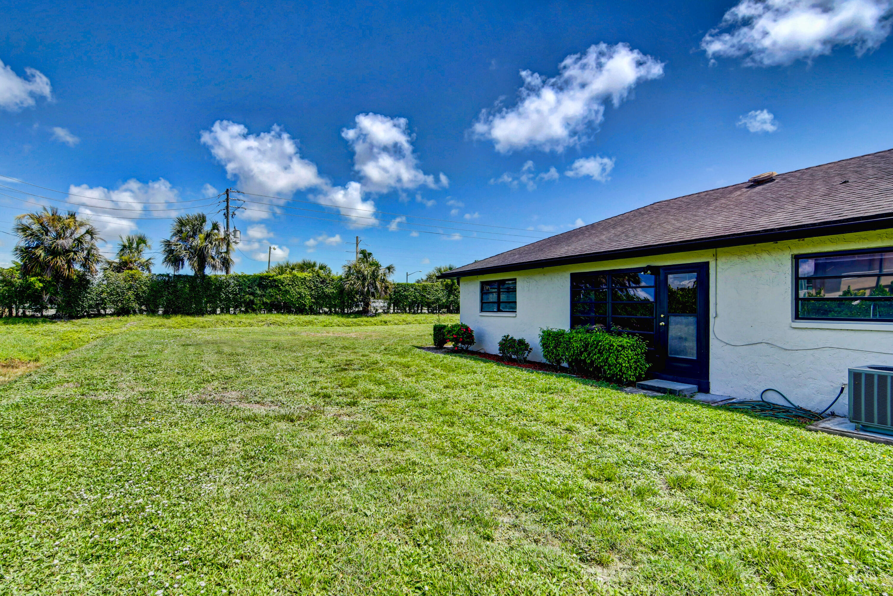 4867 Hawkwood Road, Unit B Boynton Beach, FL 33436 - Photo 35 of 37 a front view of a house with garden