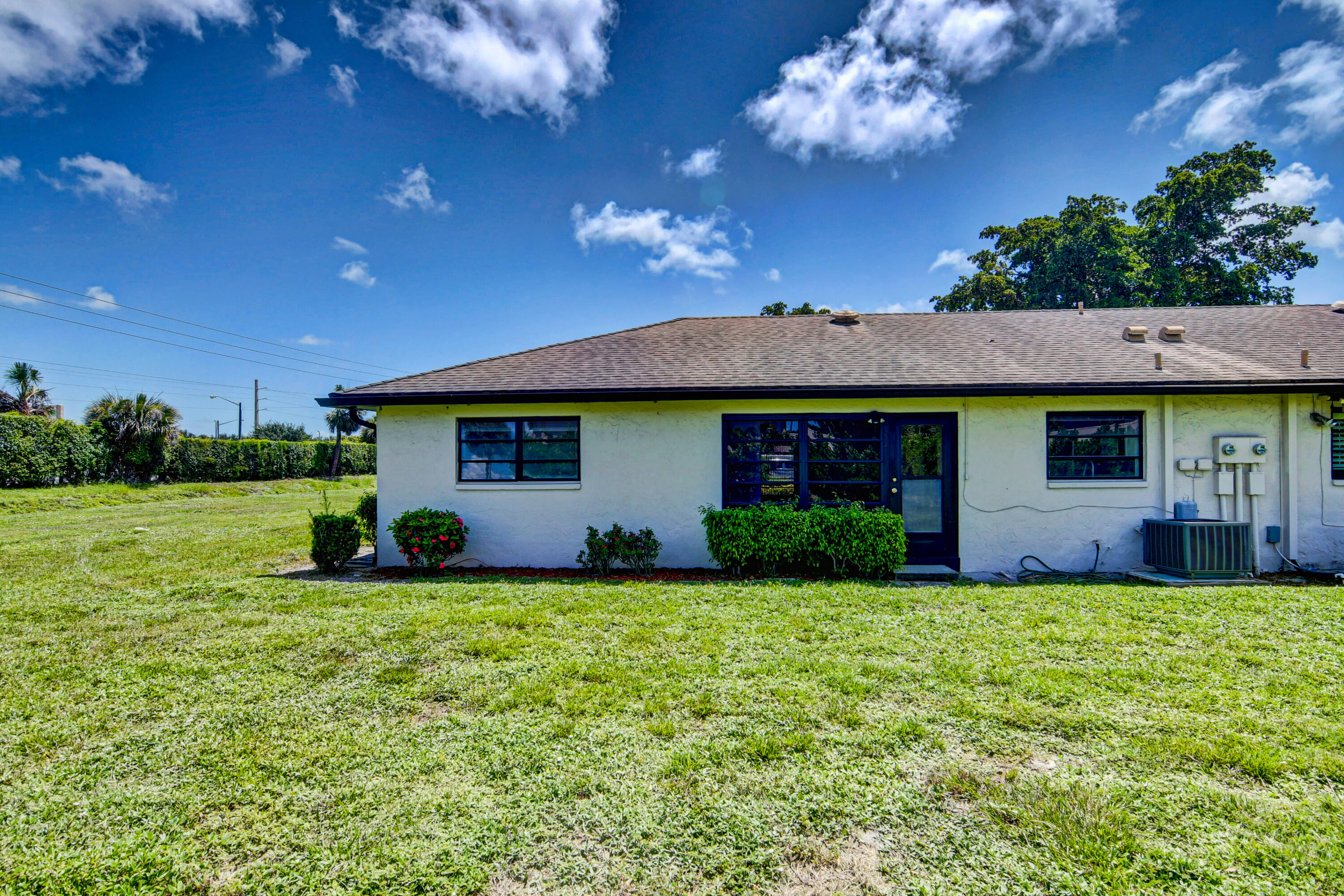 4867 Hawkwood Road, Unit B Boynton Beach, FL 33436 - Photo 37 of 37 a view of a house with a yard and a tree