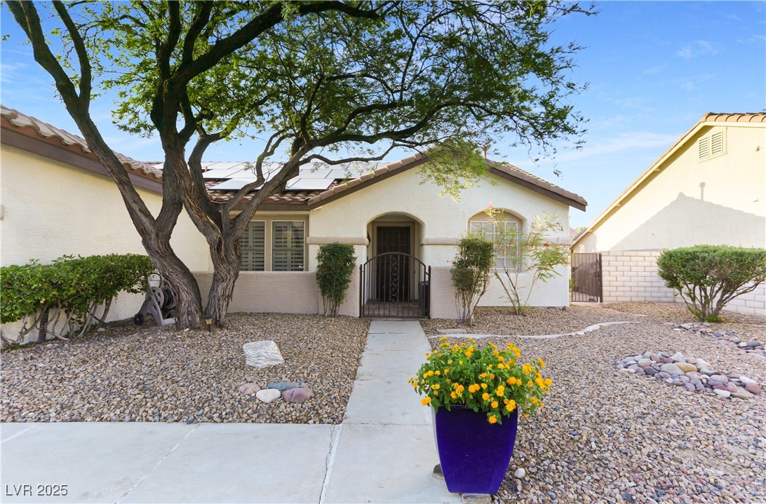 8928 Rusty Rifle Avenue Las Vegas, NV 89143 - Photo 3 of 23 The front of the home features a gated private cou