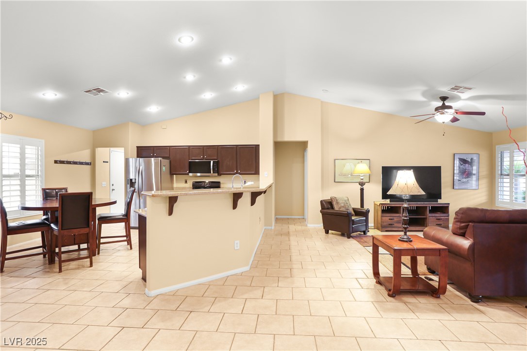 8928 Rusty Rifle Avenue Las Vegas, NV 89143 - Photo 6 of 23 Open-concept living room and kitchen create a seam