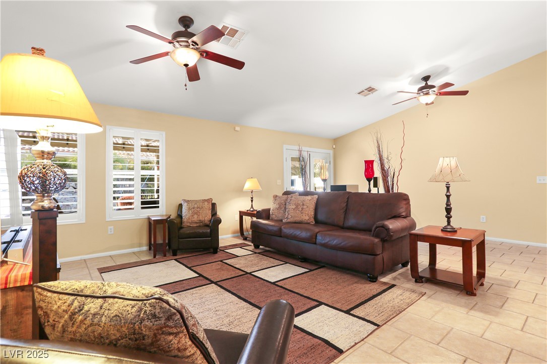 8928 Rusty Rifle Avenue Las Vegas, NV 89143 - Photo 9 of 23 Bright living room featuring French doors and larg