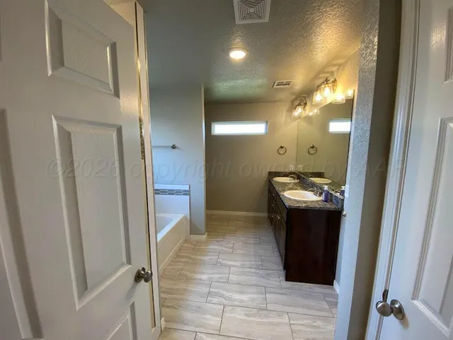 a bathroom with a sink and mirror