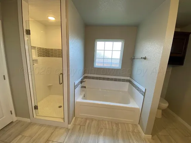 a bathroom with a tub and shower