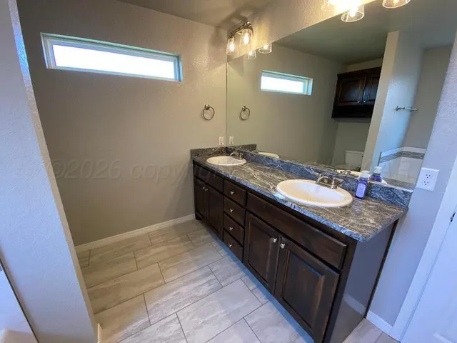 a bathroom with a sink a vanity and a mirror