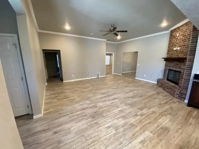 wooden floor in an empty room with a fireplace
