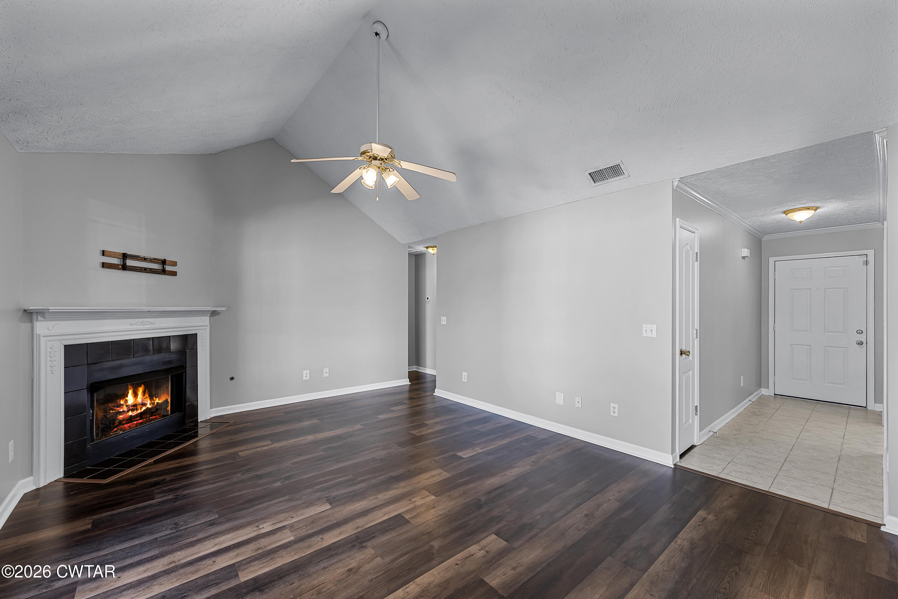 75 Suncrest Drive Jackson, TN 38305 - Photo 11 of 24 a view of an empty room with wooden floor fireplace and a window