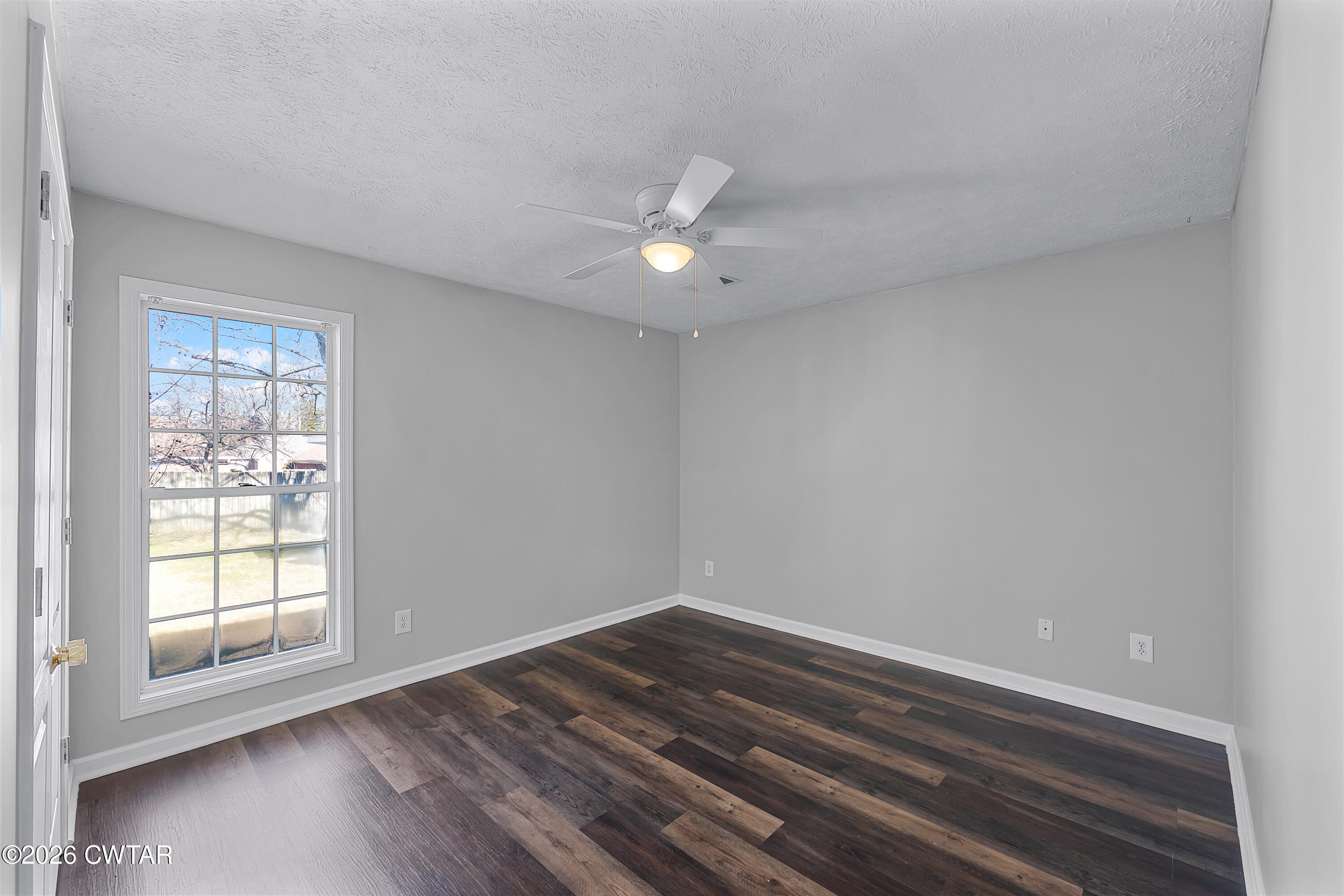 75 Suncrest Drive Jackson, TN 38305 - Photo 15 of 24 wooden floor in an empty room with a window