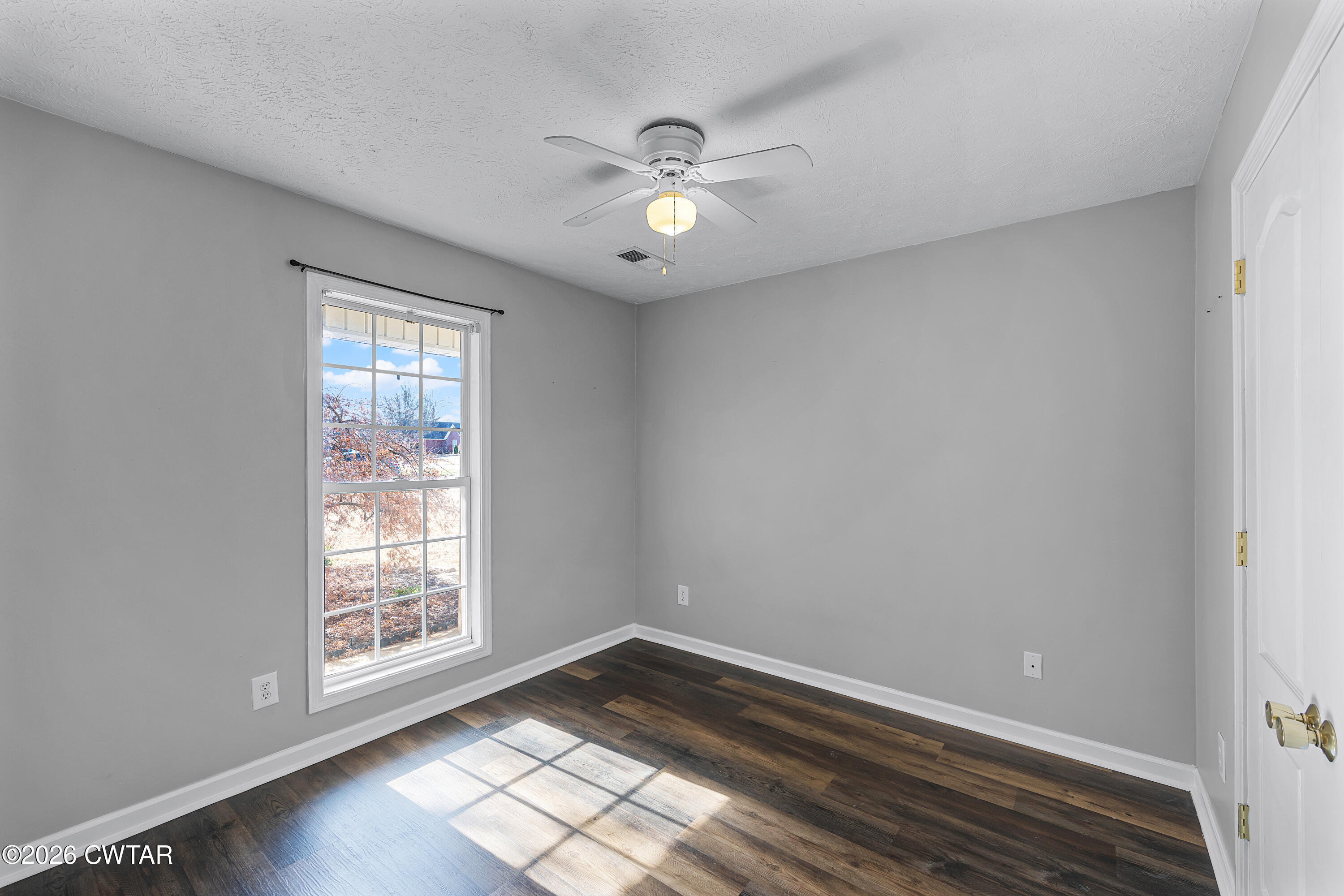 75 Suncrest Drive Jackson, TN 38305 - Photo 17 of 24 wooden floor in an empty room with a window