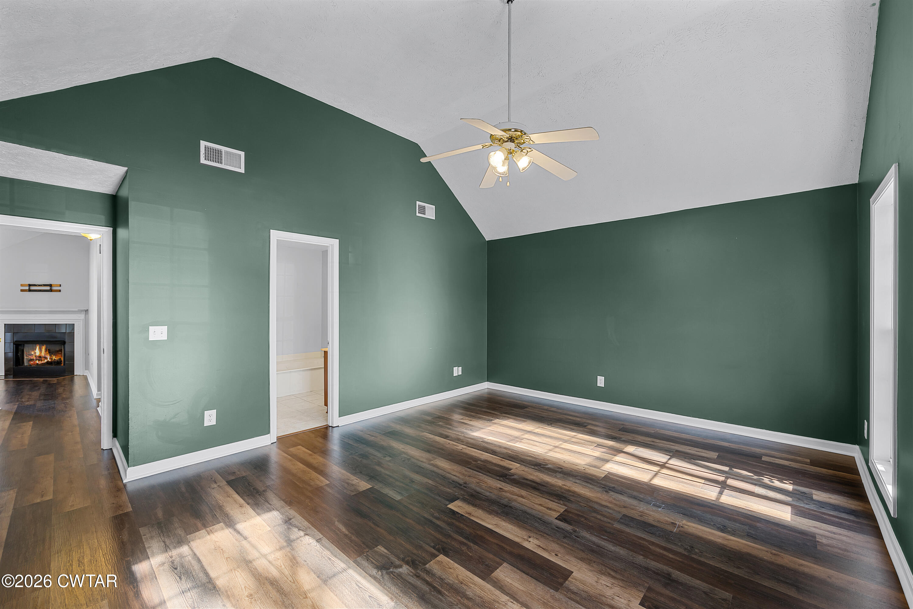 75 Suncrest Drive Jackson, TN 38305 - Photo 19 of 24 a bedroom with a bed and a chandelier
