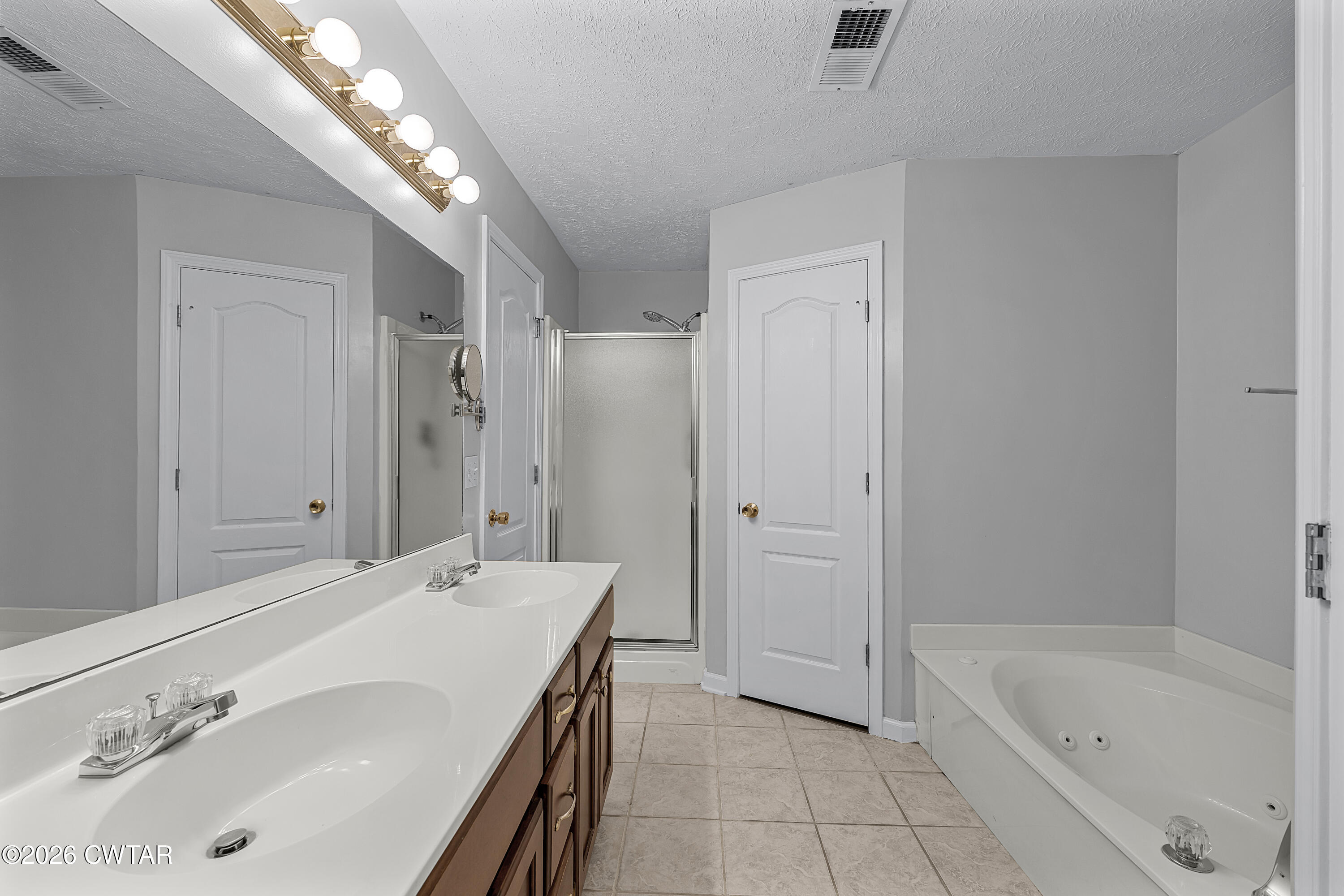 75 Suncrest Drive Jackson, TN 38305 - Photo 20 of 24 a spacious bathroom with a tub sink and mirror