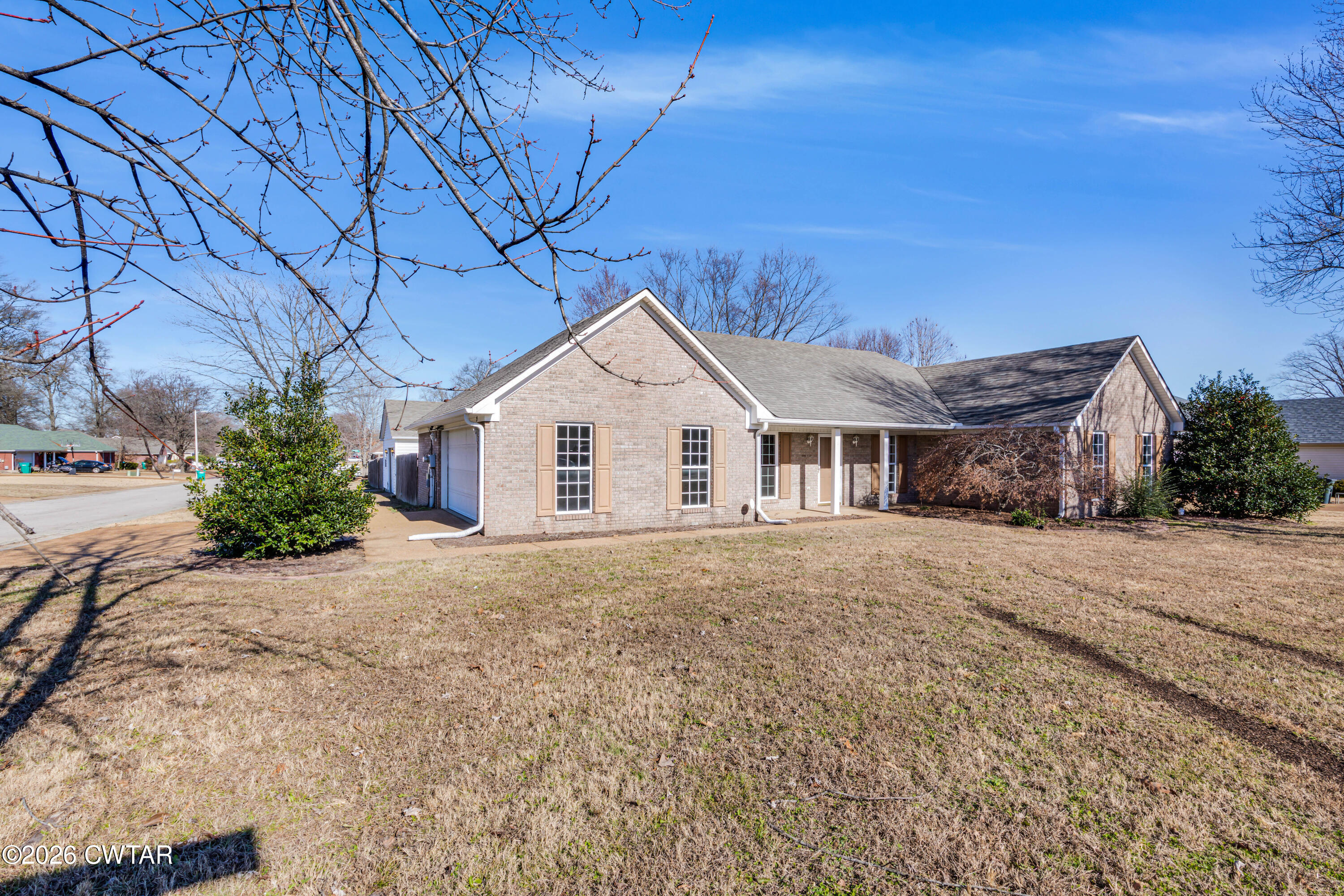 75 Suncrest Drive Jackson, TN 38305 - Photo 2 of 24 a view of a house with a yard and garage