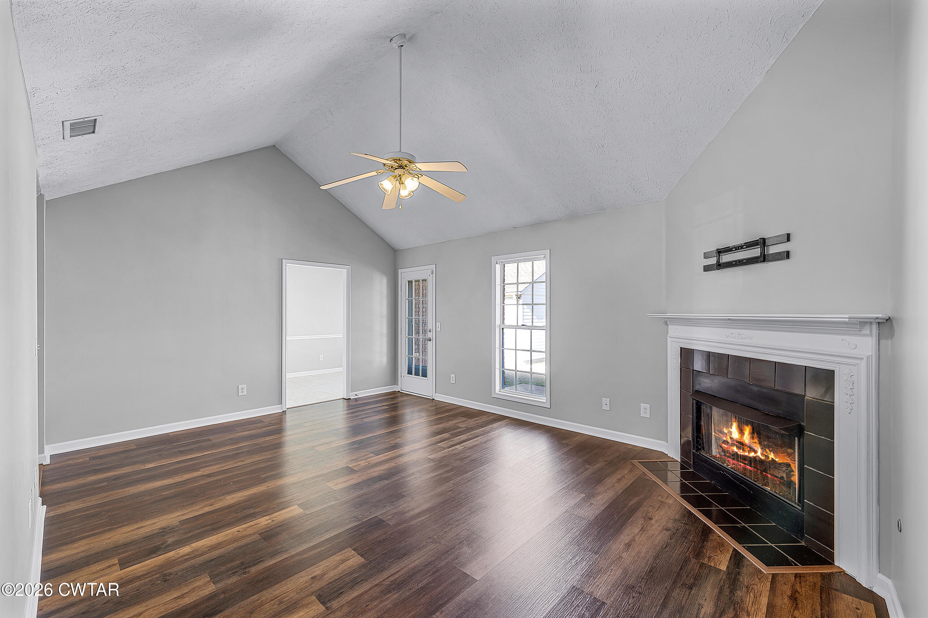 75 Suncrest Drive Jackson, TN 38305 - Photo 3 of 24 a view of an empty room with a fireplace and a window
