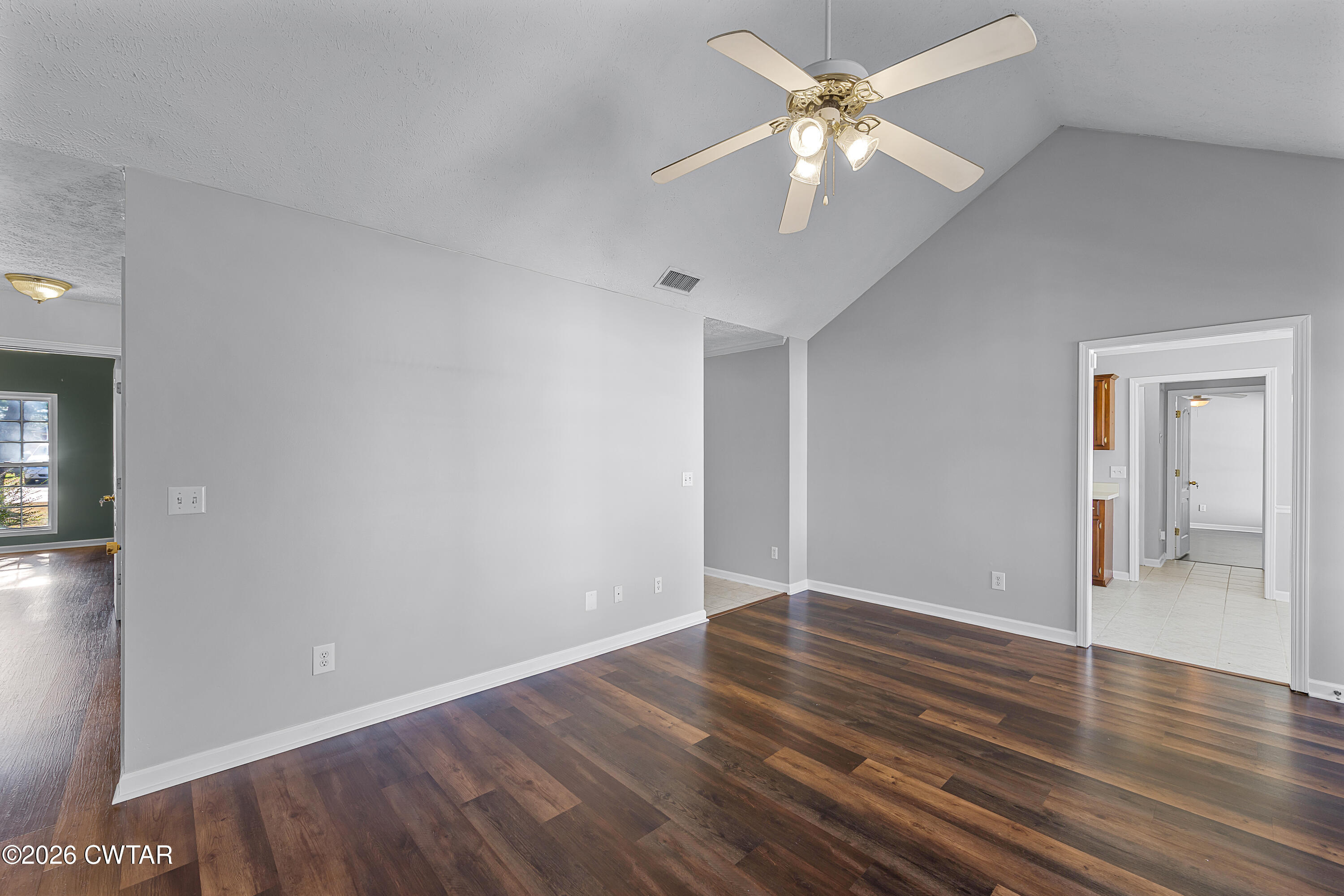 75 Suncrest Drive Jackson, TN 38305 - Photo 5 of 24 a view of an empty room with window and wooden floor