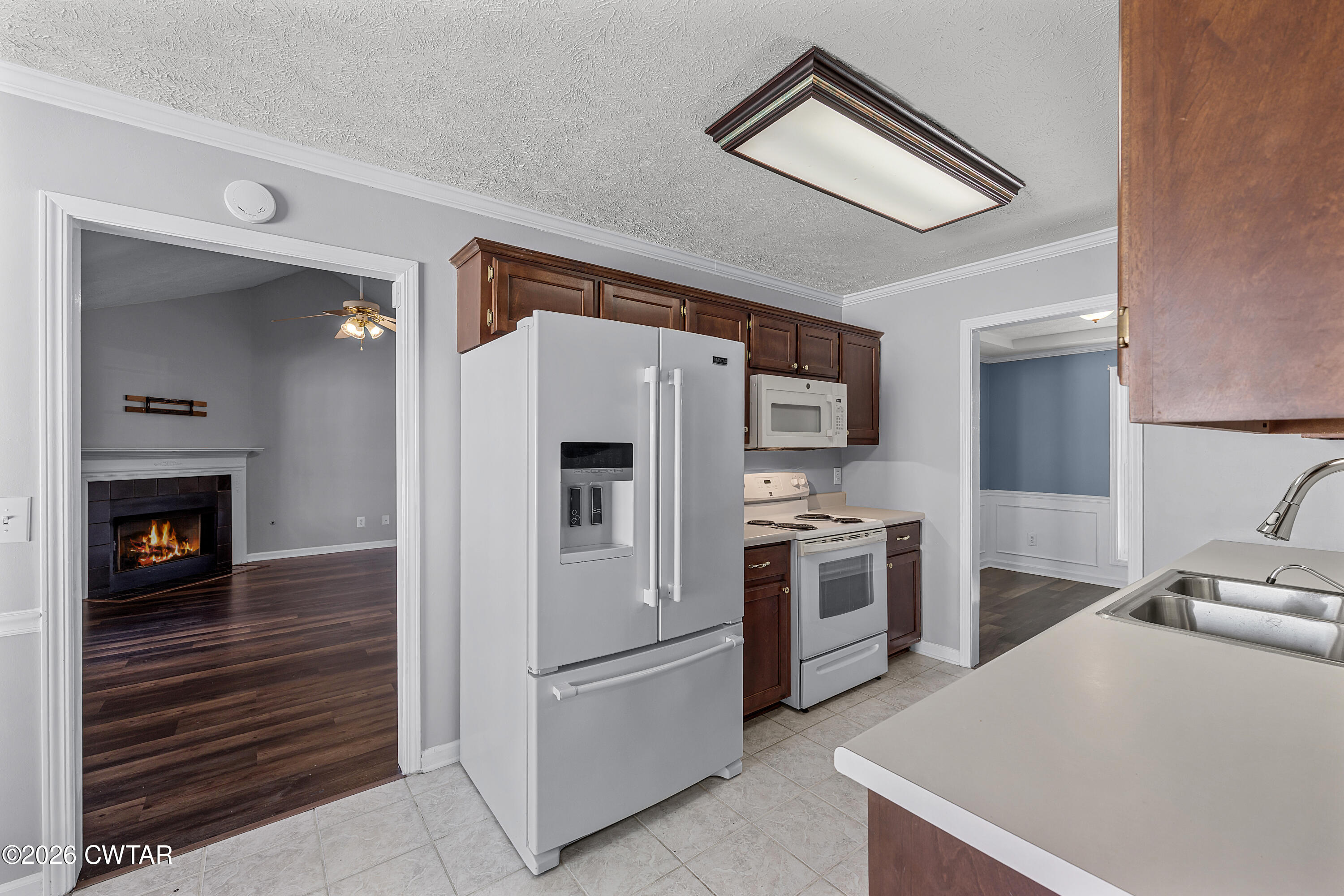75 Suncrest Drive Jackson, TN 38305 - Photo 7 of 24 a kitchen with stainless steel appliances a refrigerator a stove and white cabinets