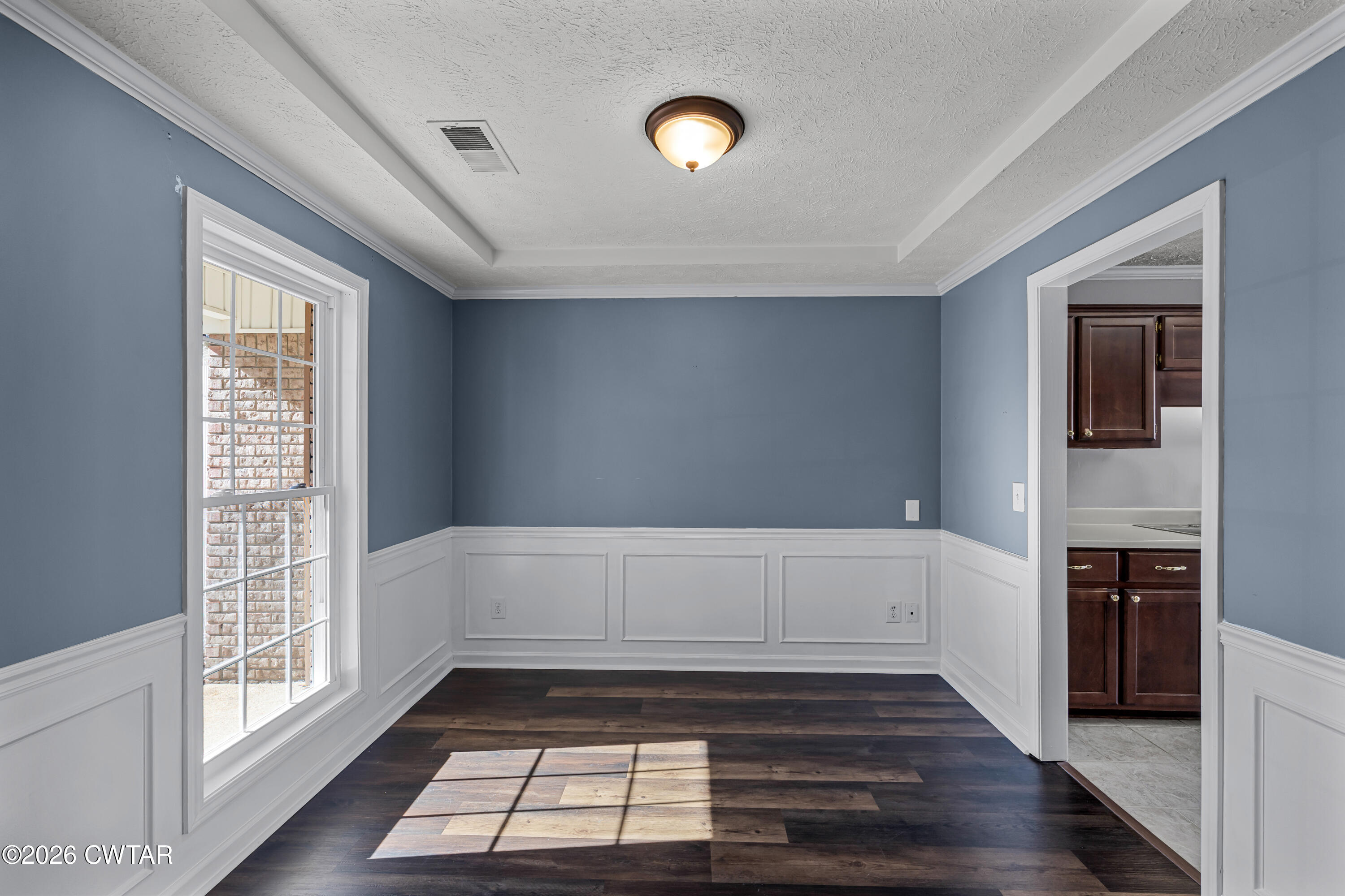 75 Suncrest Drive Jackson, TN 38305 - Photo 9 of 24 a view of an empty room with wooden floor and a window