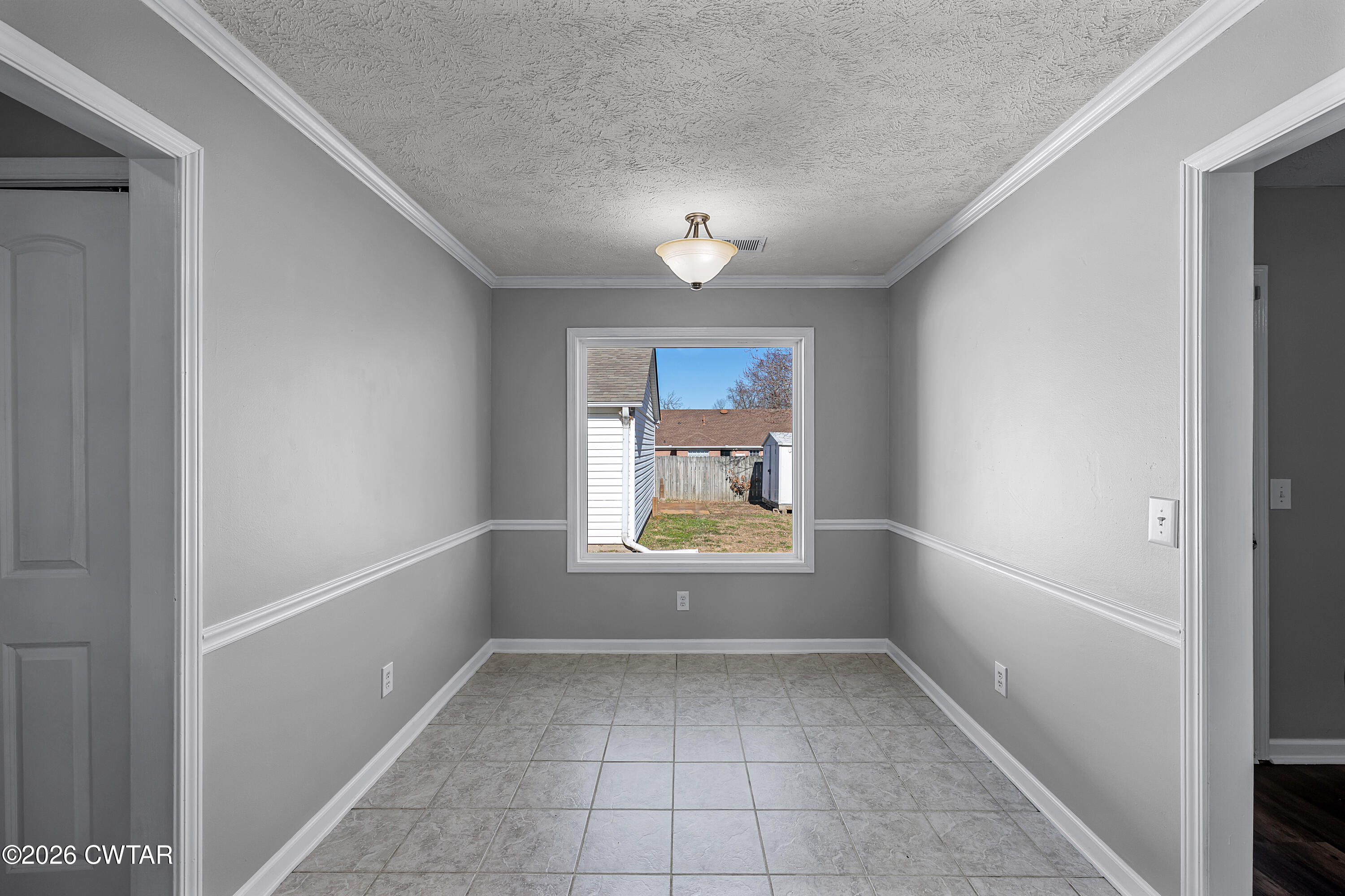 75 Suncrest Drive Jackson, TN 38305 - Photo 10 of 24 an empty room with a window and chandelier fan