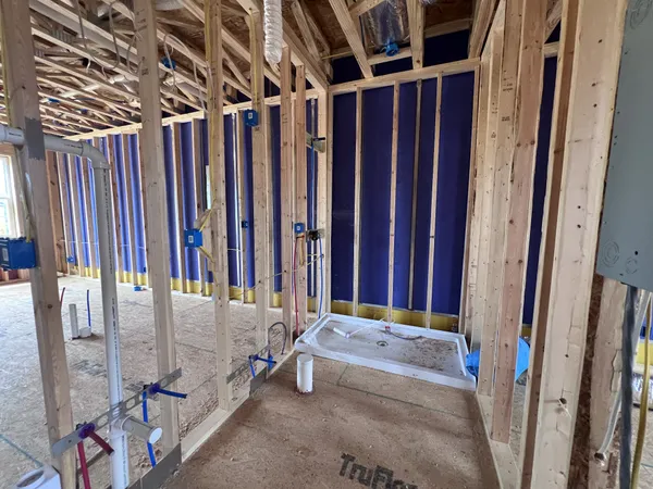 a view of walk in closet with clothes