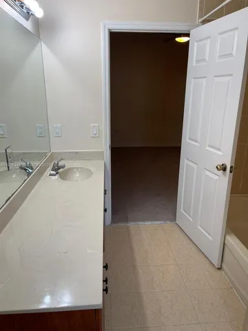 a view of a hallway with wooden floor and entryway