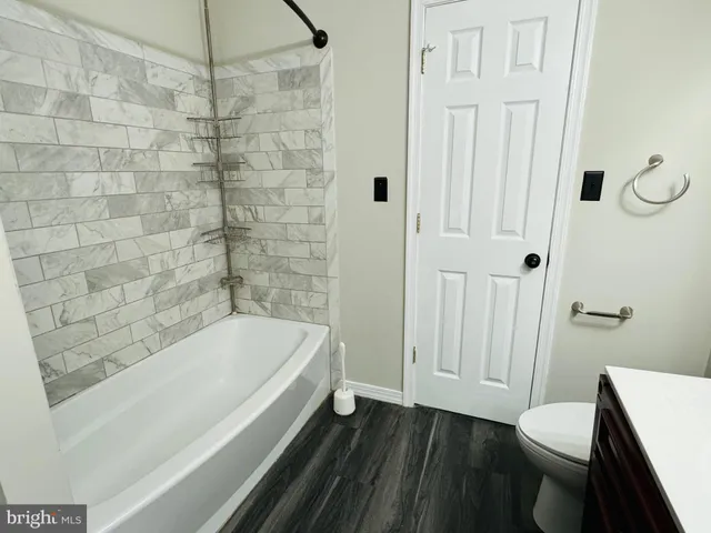 a bathroom with a bathtub and shower